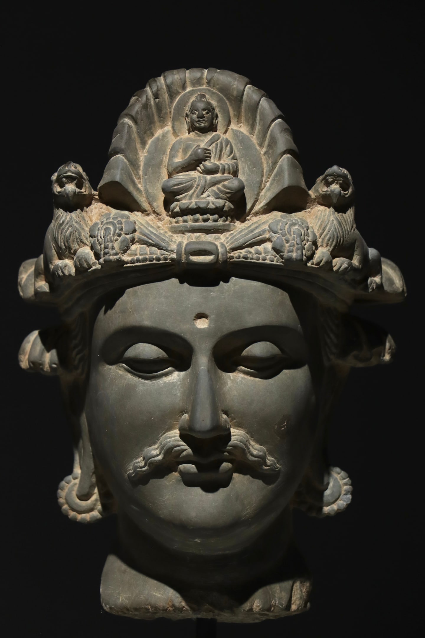 3rd century Gandhara art: Height:53cm Height:30cm Grey stone Gandhara Buddhist deity head, blending Greco-Buddhist carving style, with crown carved Buddha and lions, classic ancient Central Asian stone Buddha sculpture.