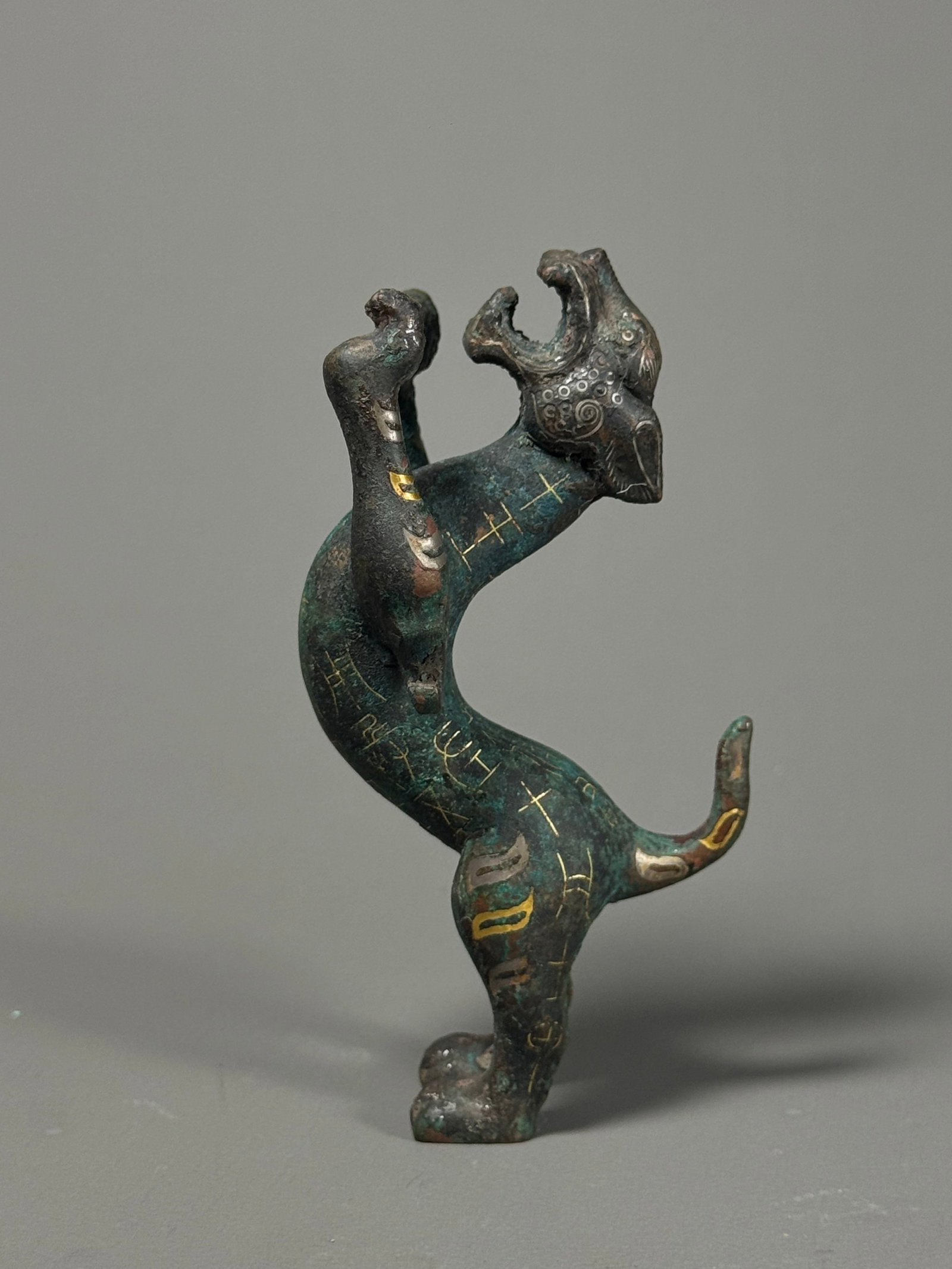 Warring States Inlaid gold and silver inscription copper walking dragon building: Height:10cm(3.94in), Width:5cm(1.97in), Weight:388g (0.856lb)Warring States Bronze Coiled Dragon Fitting with Gold & Silver Inlaid InscriptionsBronze standing chilong ornament twisted in dynamic
