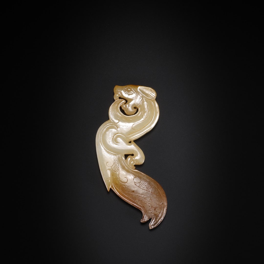 Han Hetian Jade Dragon Pendant: Long:6.6cm(2.60in), Width:2.3cm(0.91in), Thick:0.5cm(0.20in), Weight:17g (0.037lb)Crafted from mild Hetian white jade gradually tinged with light brown natural patina. Designed in an elegant S-shape,