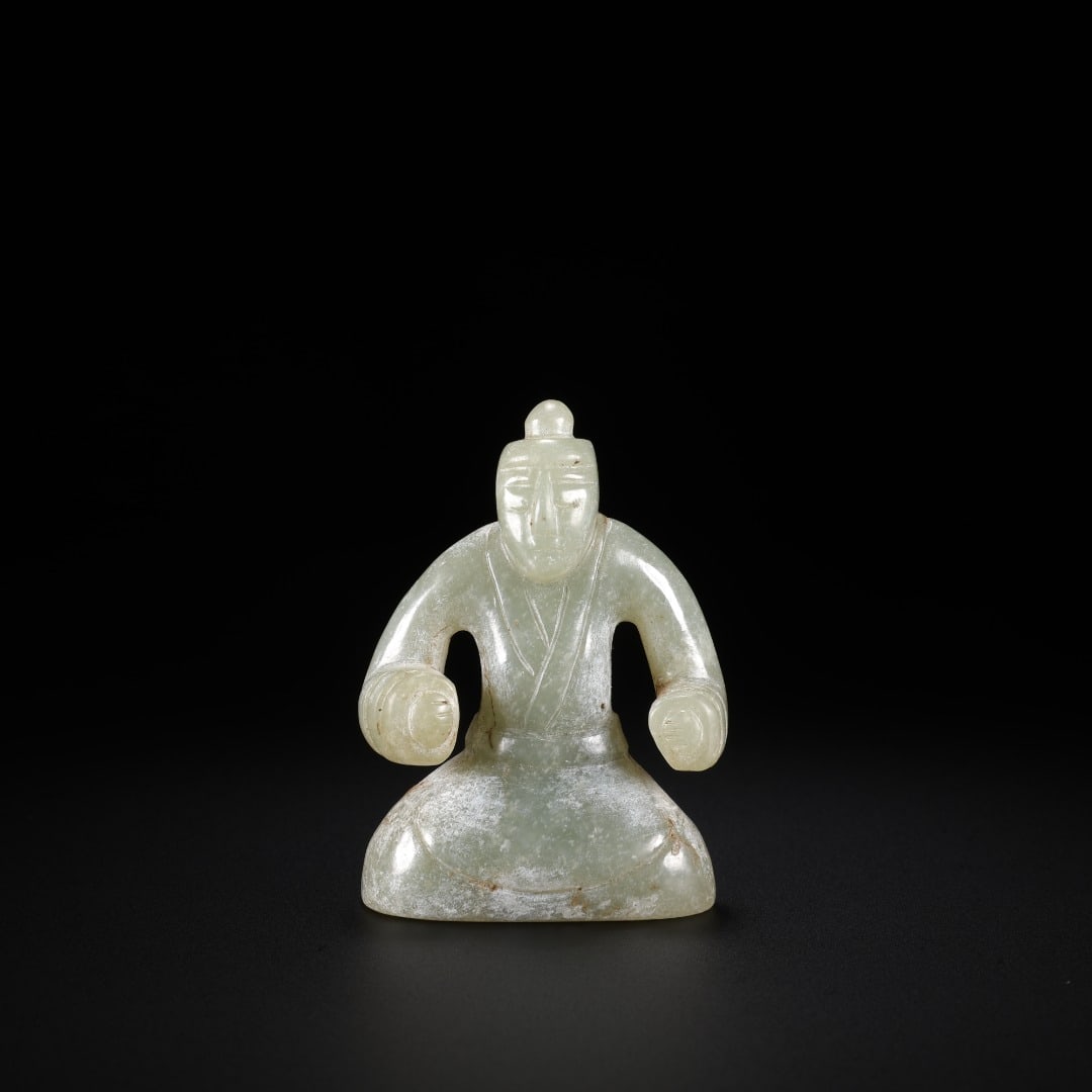 Han Hetian jade Kneeling man: Long:3.5cm(1.38in), Width:2.5cm(0.98in), Height:5cm(1.97in), Weight:43g (0.095lb)Carved from mild Hetian green jade with ancient weathering traces. The figure presents the traditional ancient Chinese 