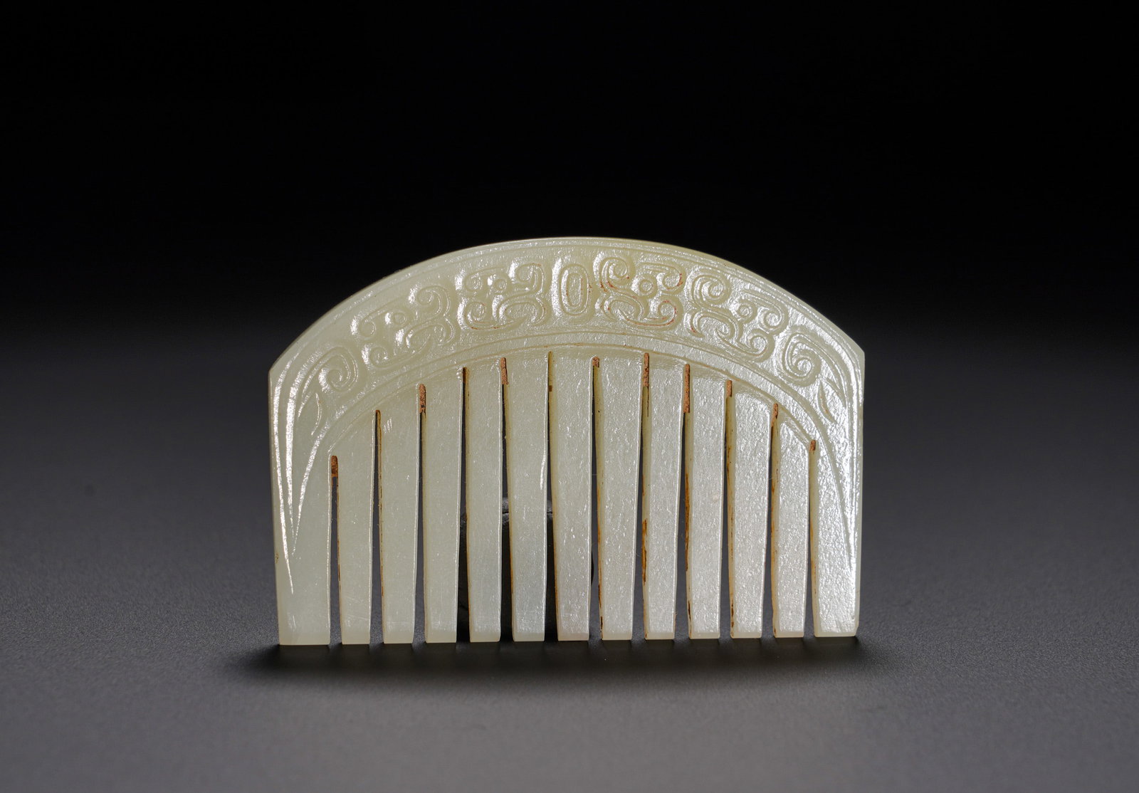 Han Dynasty Hetian jade hook cloud pattern jade comb: Height:4.5cm(1.77in), Width:6.7cm(2.64in), Weight:40g (0.088lb)Hetian White Jade Comb Carved with Archaic Interlocking Cloud PatternsCrafted from Hetian white jade with fine, mellow texture and