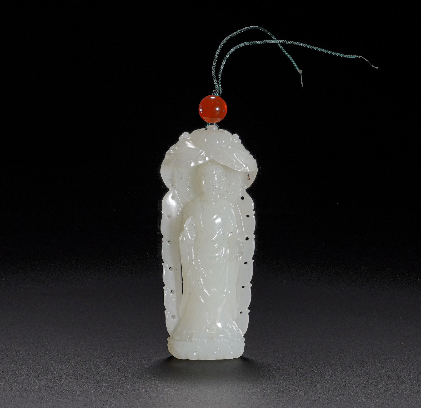 Qing Dynasty Hetian jade pendant of Sakyamuni Buddha: Height:6.5cm(2.56in), Width:2.7cm(1.06in), Weight:30g (0.066lb)Hetian White Jade Openwork Pendant with Standing Shakyamuni BuddhaCarved from Hetian white jade featuring fine, lustrous texture and