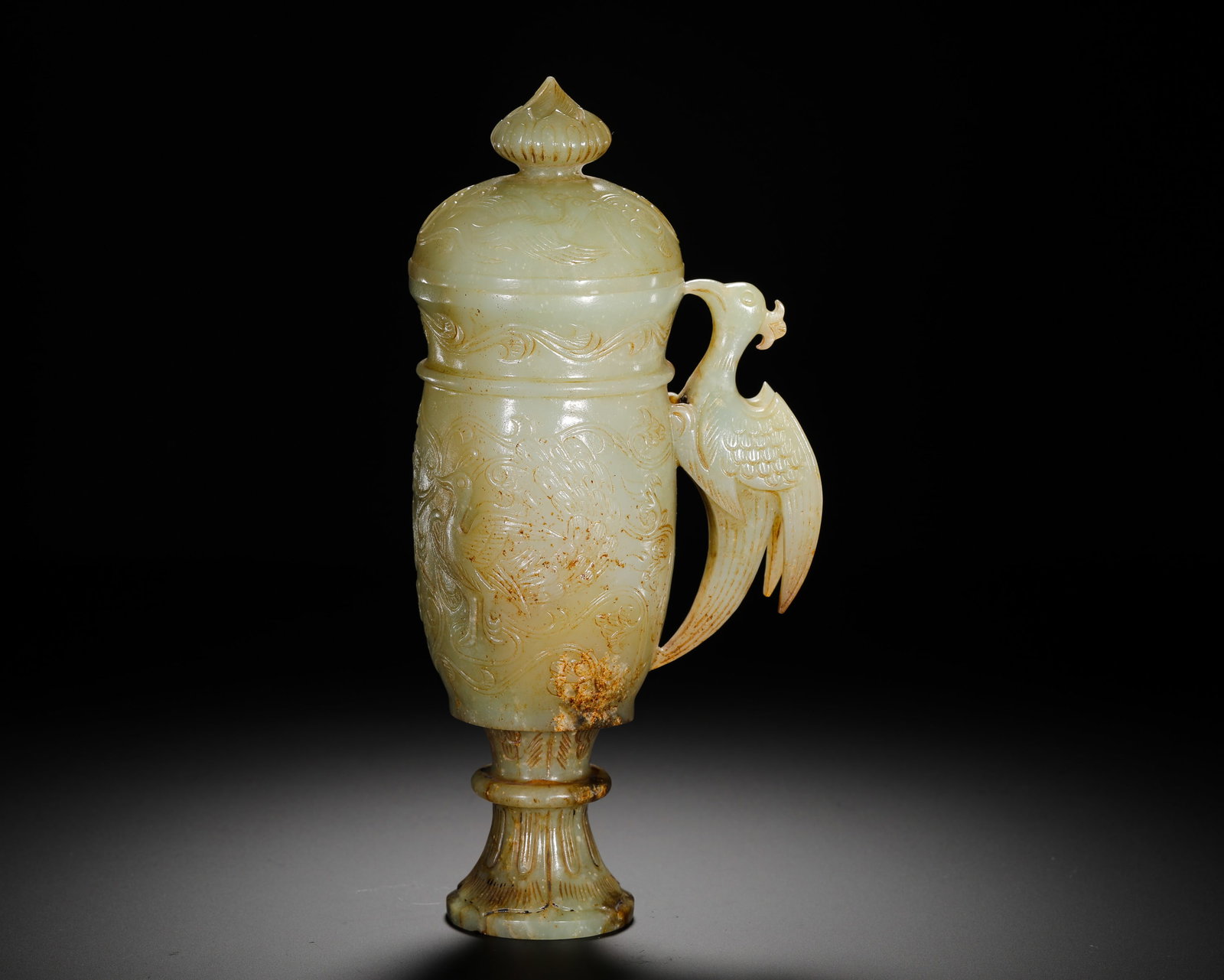 Qing Dynasty Hetian jade cups: Height:21cm(8.27in) Width:10cm(3.94in) Weight:550g(1.21lb)Qing Dynasty white jade stemmed covered cup carved with phoenix patterns. Solid whole-jade hollowed carving with lotus lid, three-dimensional