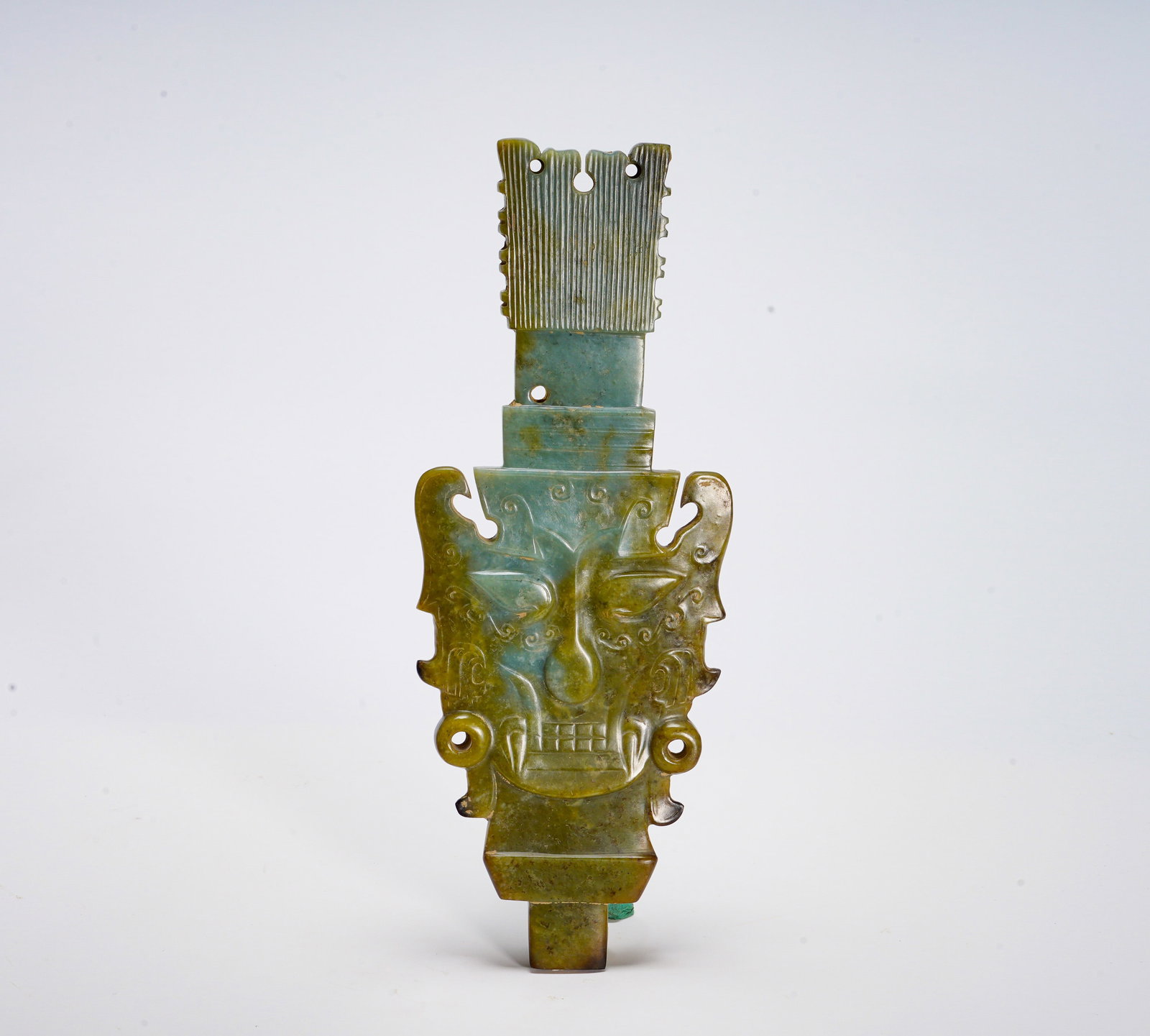 Shang Dynasty Hetian jade Divine human Face pattern jade pendant: Height:12.5cm(4.92in) Width:8.5cm(3.35in) Weight:240g(0.53lb)Modeled after ancient jade zhang ritual tablet, symmetric flanged edges, top decorated with comb pattern, central relief of divine human