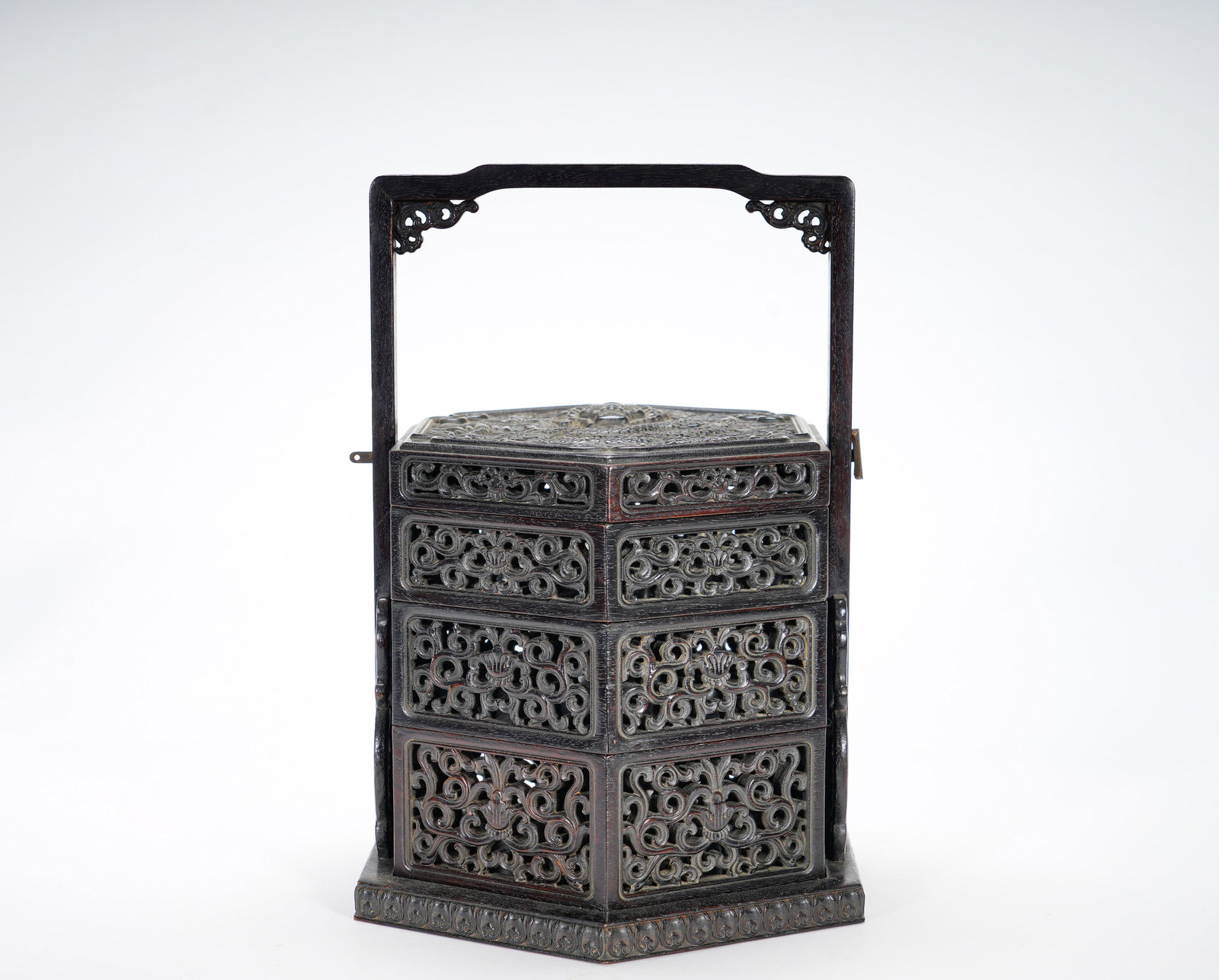 Qing Dynasty rosewood through-carving handle box: Height:27cm(10.63in), Width:22cm(8.66in), Weight:1140g (2.513lb)Zitan Hexagonal Multi-Tier Handled Box with Openwork Passionflower ScrollsExquisitely fashioned from fine zitan wood, this hexagonal