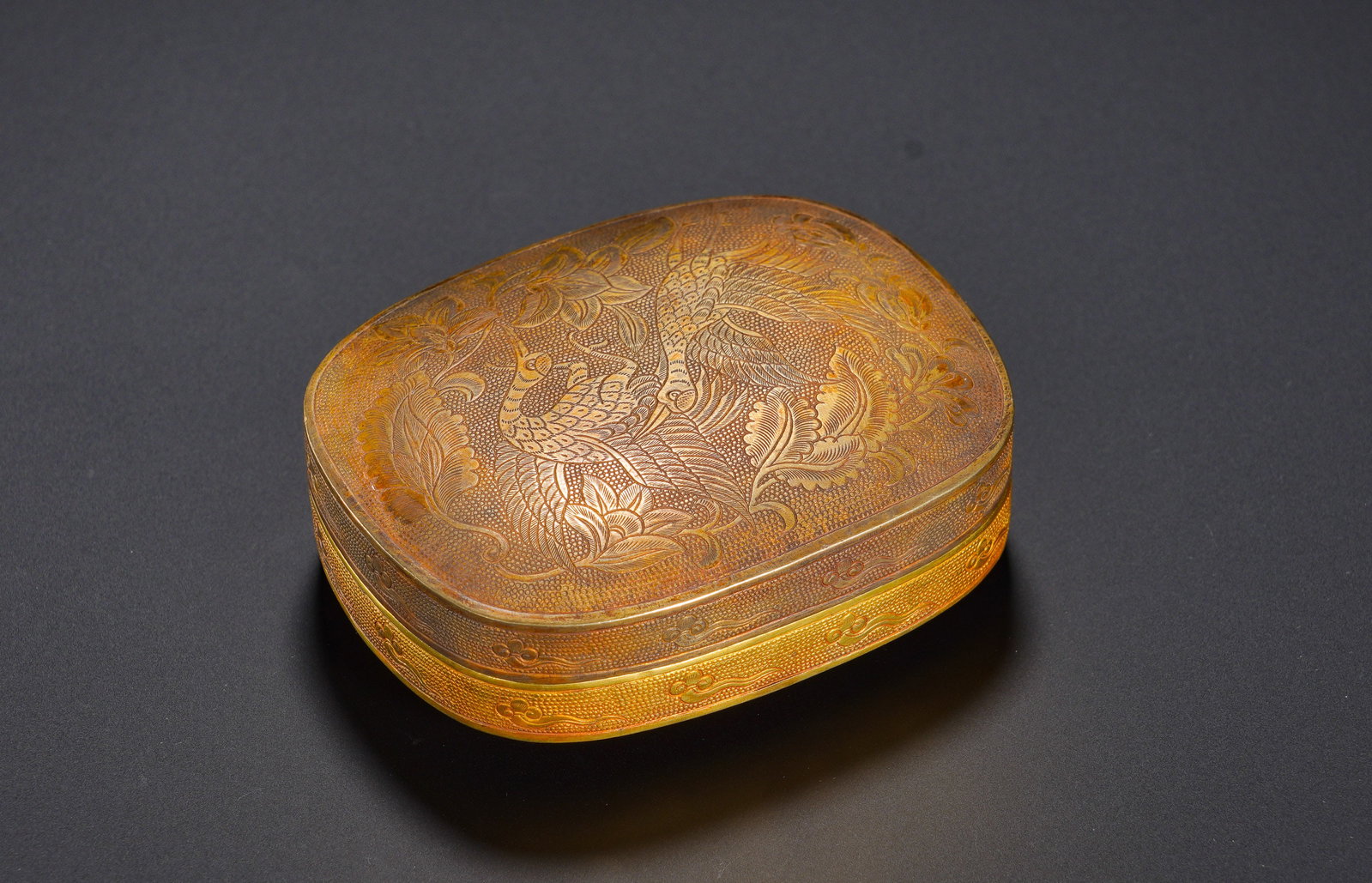 Silver-gilt engraved mother-and-child lid box of the Song Dynasty: Height:3cm(1.18in), Width:7.8cm(3.07in), Weight:148g (0.326lb)The peacock stands for nobility and good fortune, while the crane symbolises longevity. Designed to hold incense powder or pellets, it ser
