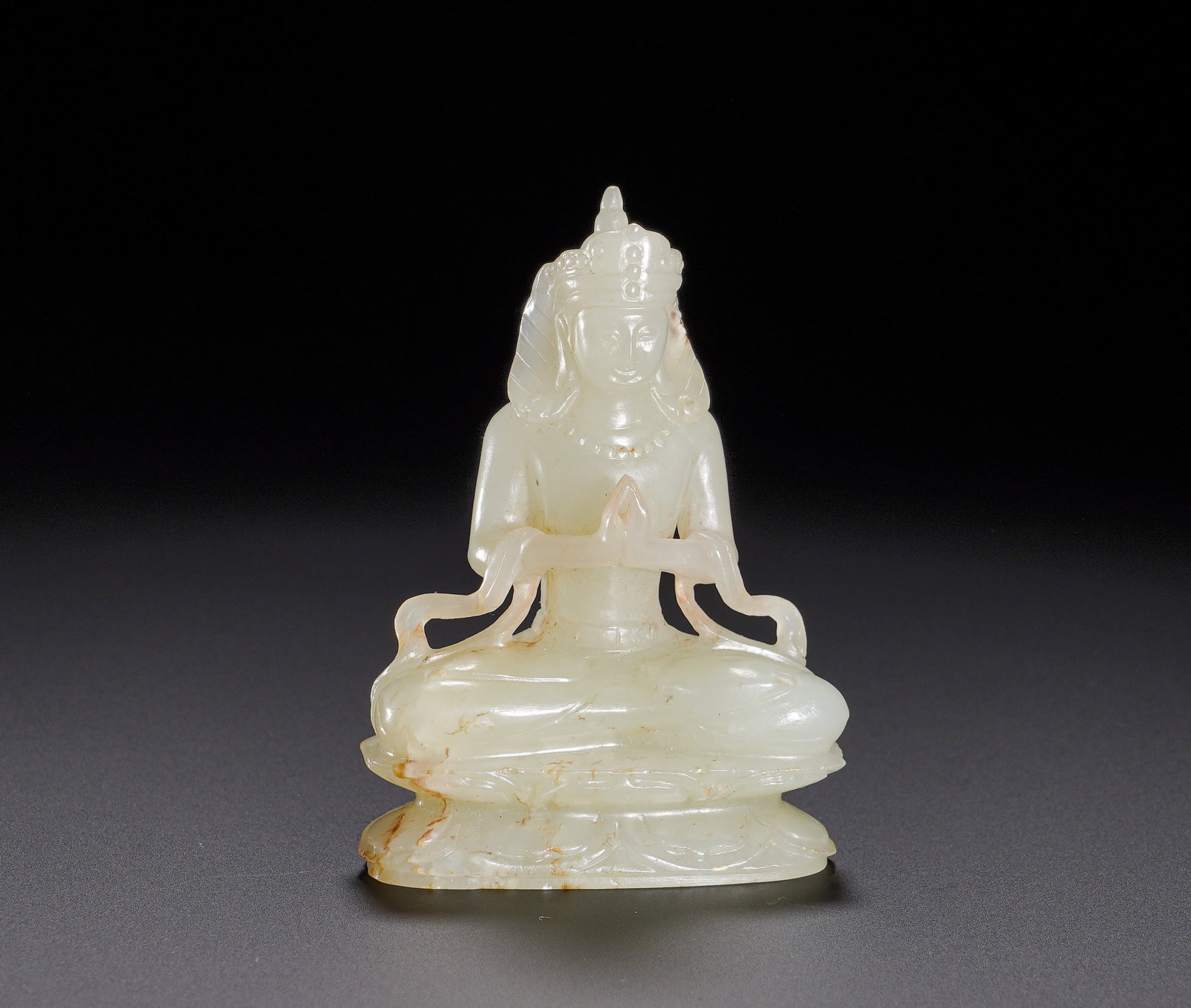 A seated statue of the Buddha of Infinite Life in Hetian jade of the Qing Dynasty: Height:7.2cm(2.83in), Width:5cm(1.97in), Weight:80g (0.176lb)Hetian White Jade Seated Amitayus BuddhaCarved from Hetian white jade with mild translucent texture and natural light russet inclusions