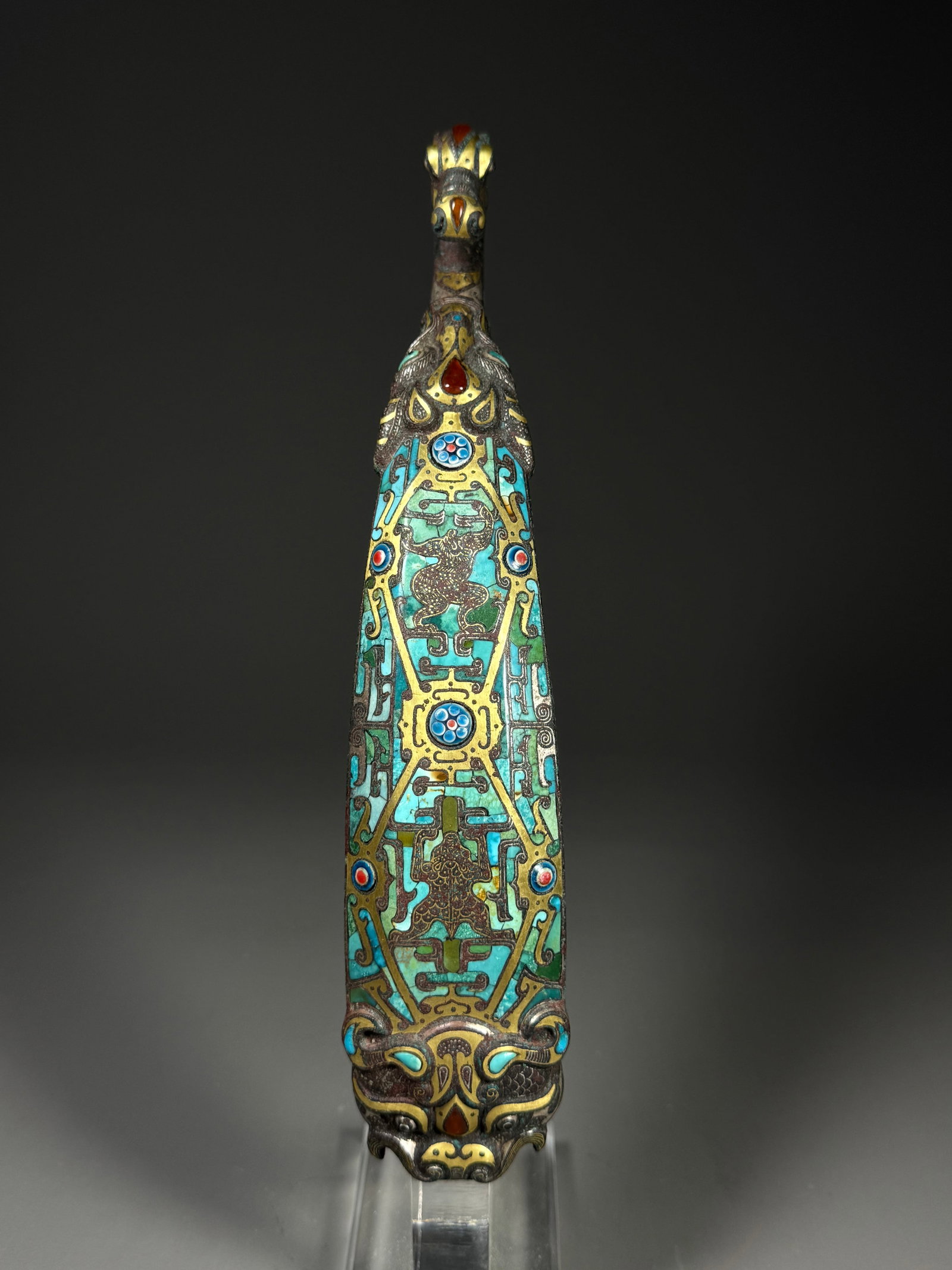 Bronze belt hook with inlaid gold and silver inlaid glazed auspicious beast pattern from the Warring: Height:26cm(10.24in), Width:5cm(1.97in)Warring States Bronze Belt Hook with Gold-Silver Inlay, Turquoise & Glass Inlaid Auspicious Beast MotifsCast in bronze, this waist hook is outlined with interwov