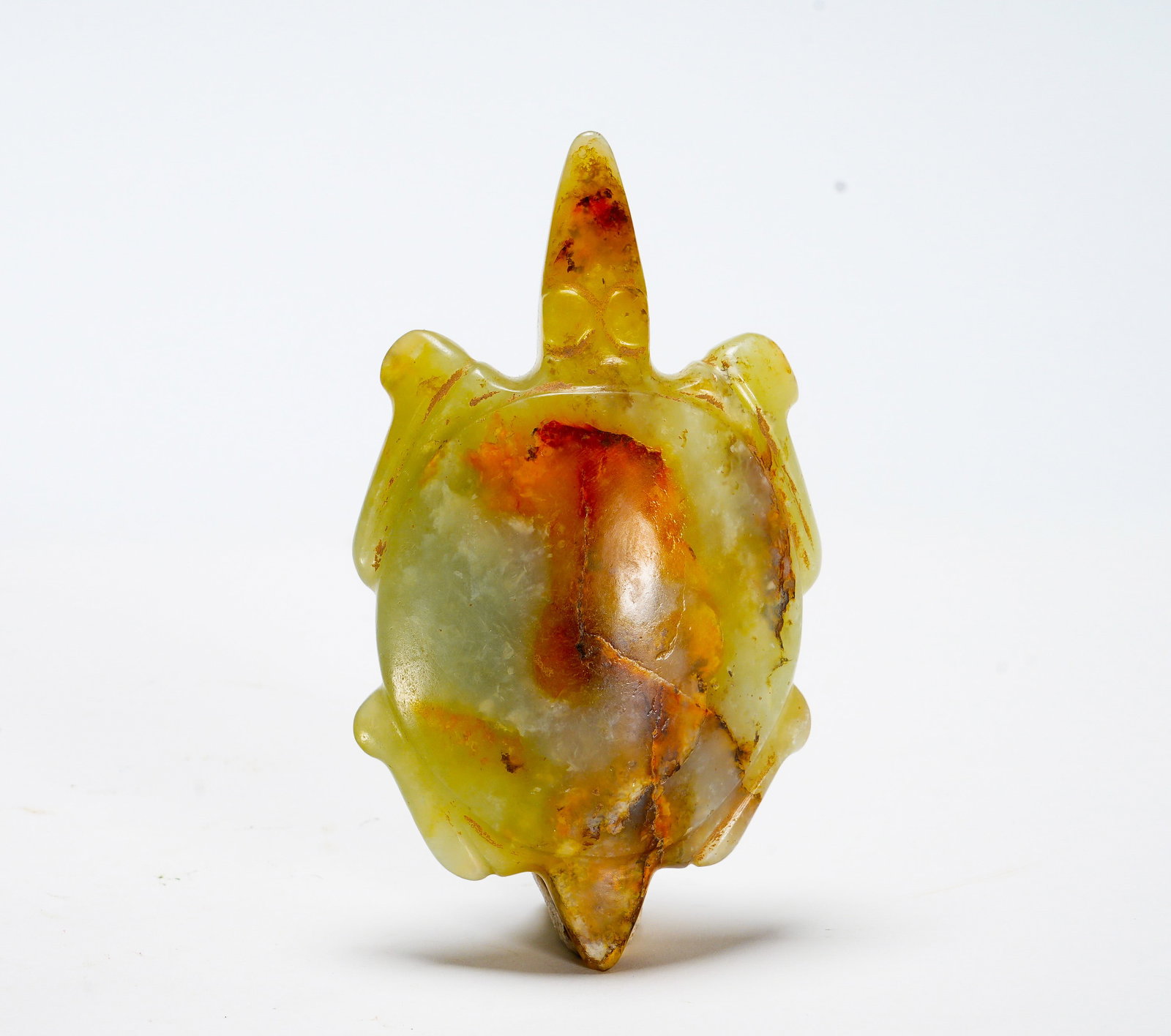 Red Mountain Culture Jade Turtle Pendant: Height:8cm(3.15in) Width:4.5cm(1.77in) Weight:60g(0.13lb)The flat turtle-shaped jade ornament with extended head and tail, smooth polished surface. Yellowish jade with natural reddish-brown burial pat
