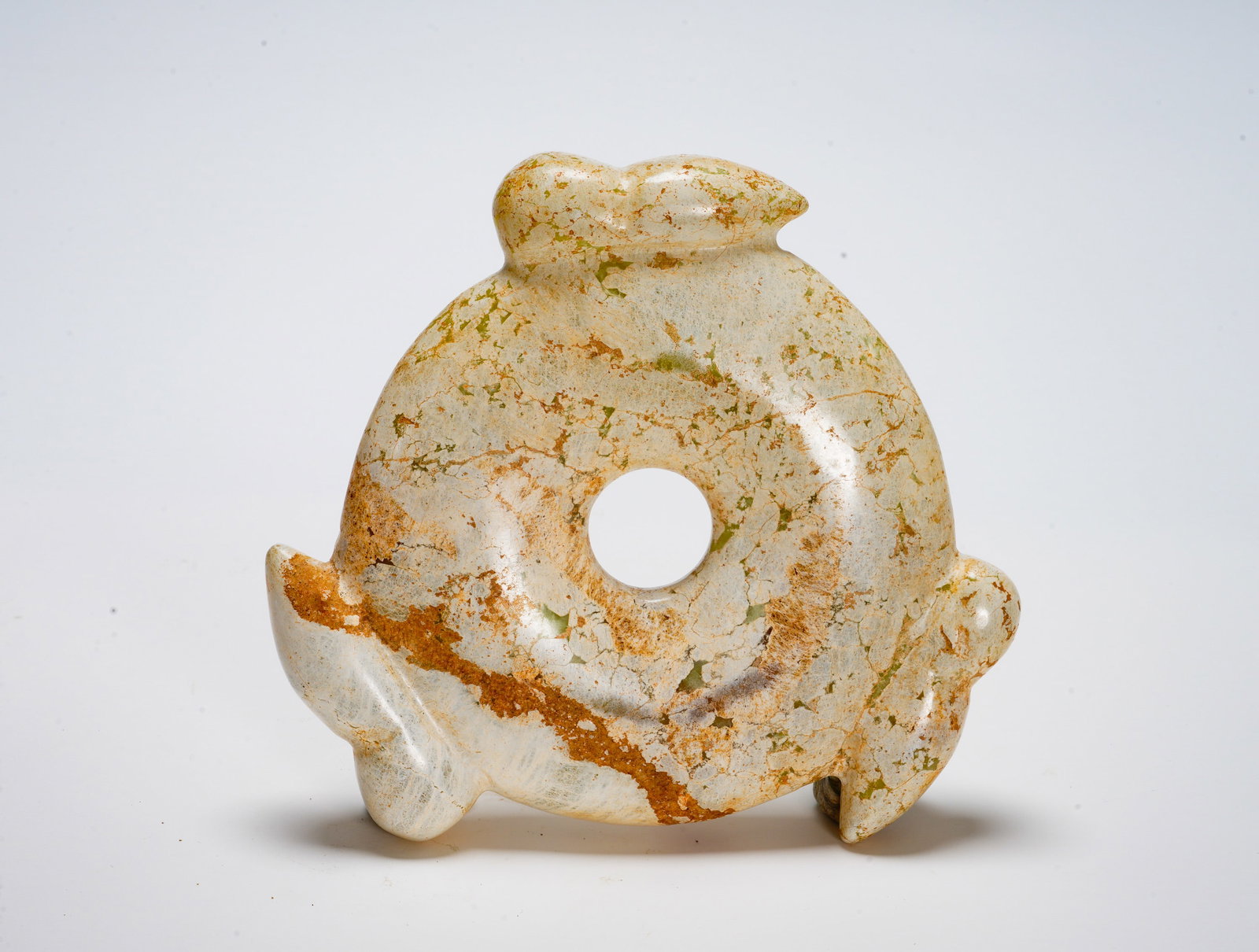 Red Mountain period Jade three-bird Ring pendant: Height:14.5cm(5.71in) Width:12.3cm(4.84in) Weight:580g(1.28lb)The circular jade ornament carved with three sacred birds around rim. Heavily calcified pale jade with russet burial patina. Ring symboliz