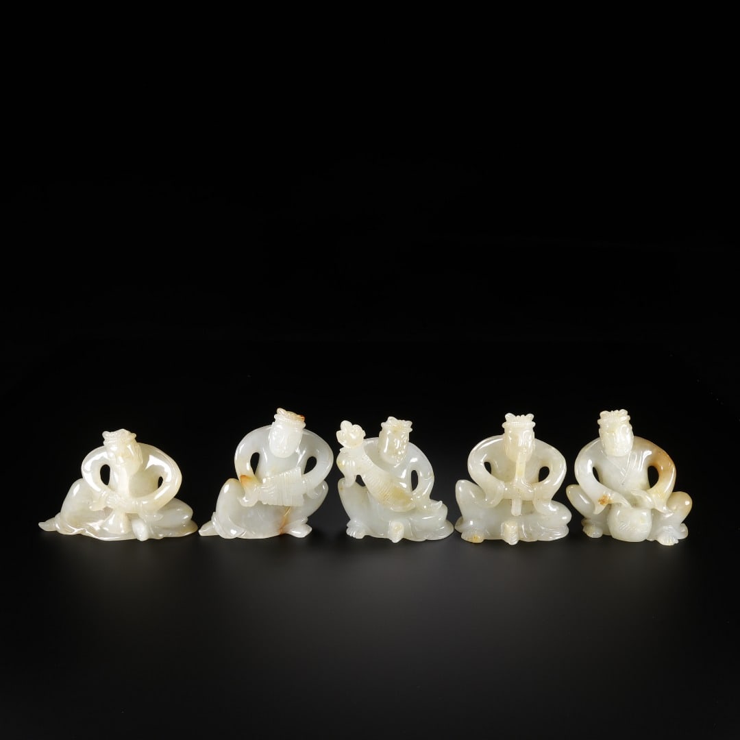 A set of five Han Hetian jade musical instrument players: Long:7.8cm(3.07in), Width:3.4cm(1.34in), Height:5.7cm(2.24in), Weight:110g (0.243lb)The set consists of five musician statues carved from Hetian white jade, with translucent texture and natural russet