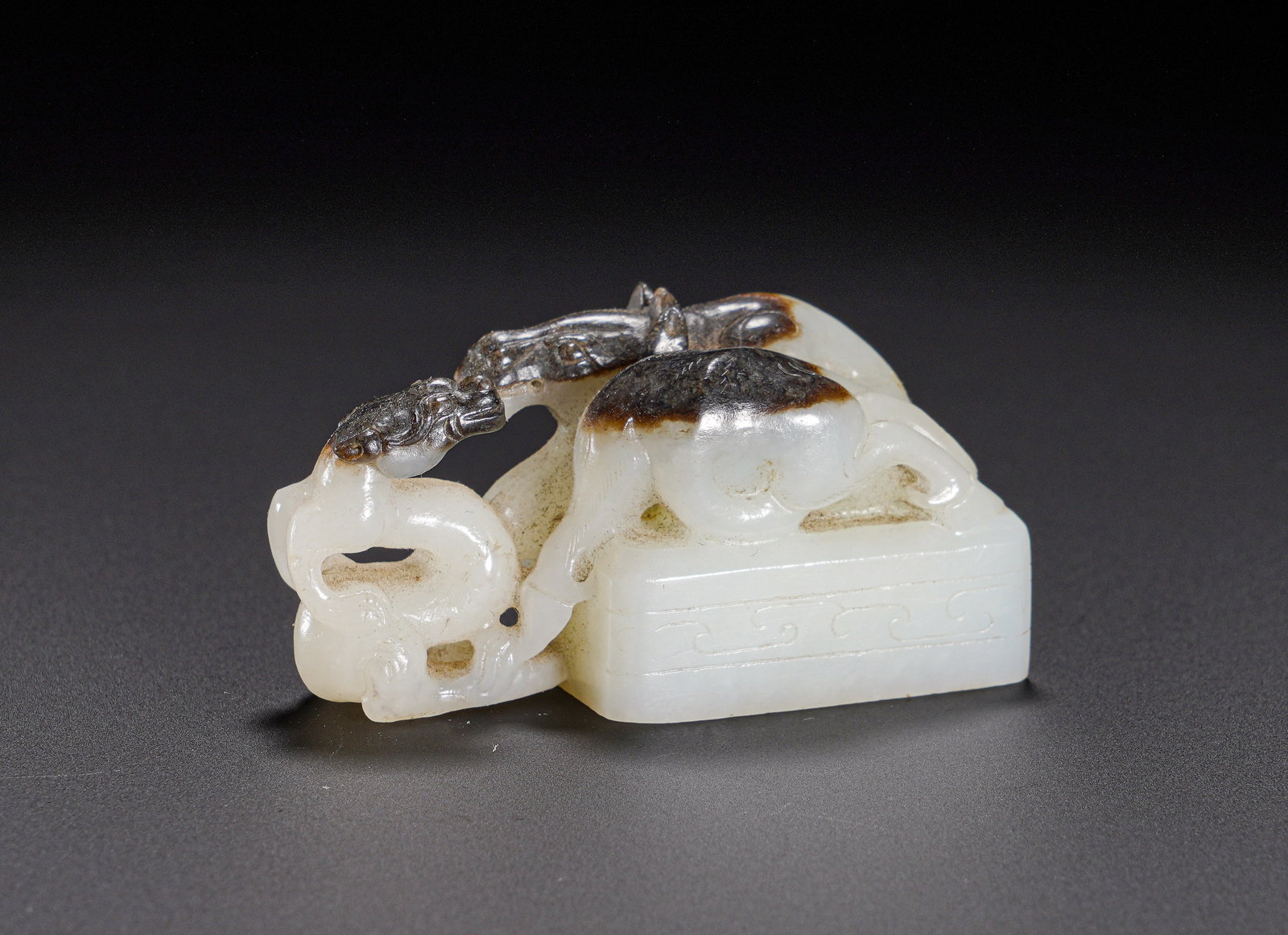 Han Dynasty Hetian jade Dragon Horse Seal: Height:3cm(1.18in), Width:5.9cm(2.32in), Weight:60g (0.132lb)Hetian White Jade Seal with Skillfully Carved Dragon and Horse Knob Utilizing Natural Dark SkinCarved from Hetian white jade with smooth an