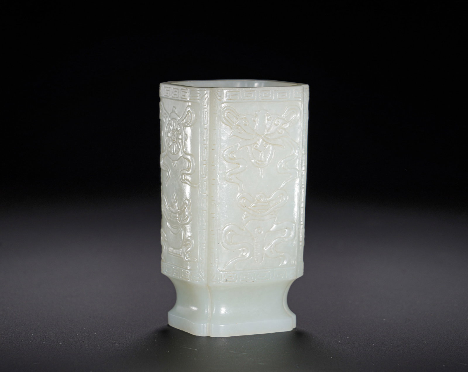 Qing Dynasty Hetian jade relief with eight auspicious patterns ?: Height:8.8cm(3.46in), Width:4.8cm(1.89in), Weight:170g (0.375lb)Hetian White Jade Rounded-Corner Square Vase with Relief Eight Auspicious SymbolsCarved from solid Hetian white jade with dense, mellow