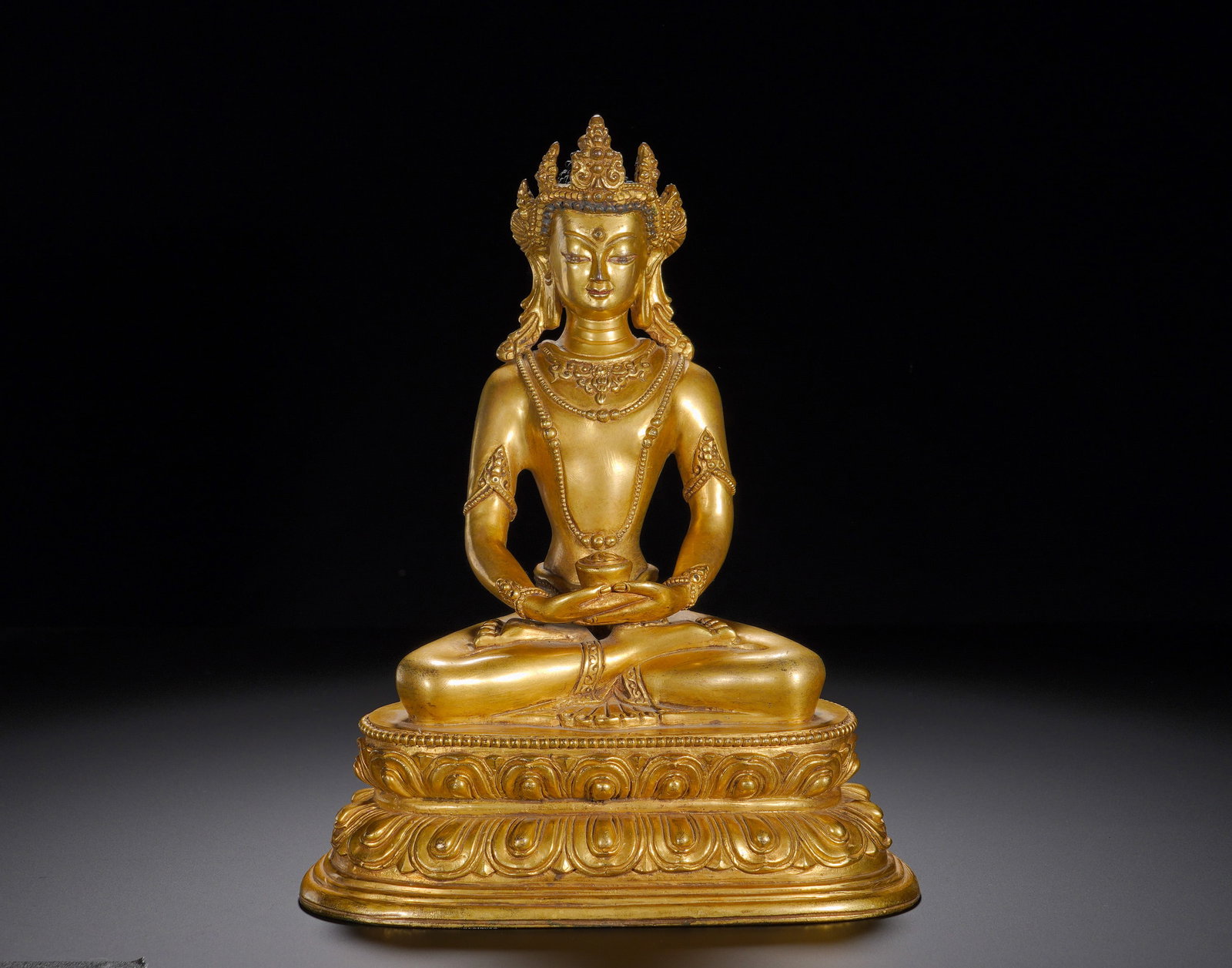 A gilded bronze Buddha of Infinite Life from Xuande of the Ming Dynasty: Height:25cm(9.84in), Width:19cm(7.48in), Weight:2610g (5.754lb)Gilt Bronze Amitayus Buddha, Inscribed “Bestowed in the Yongle Reign of the Great Ming Dynasty”This statue depicts Amitayus of Ti