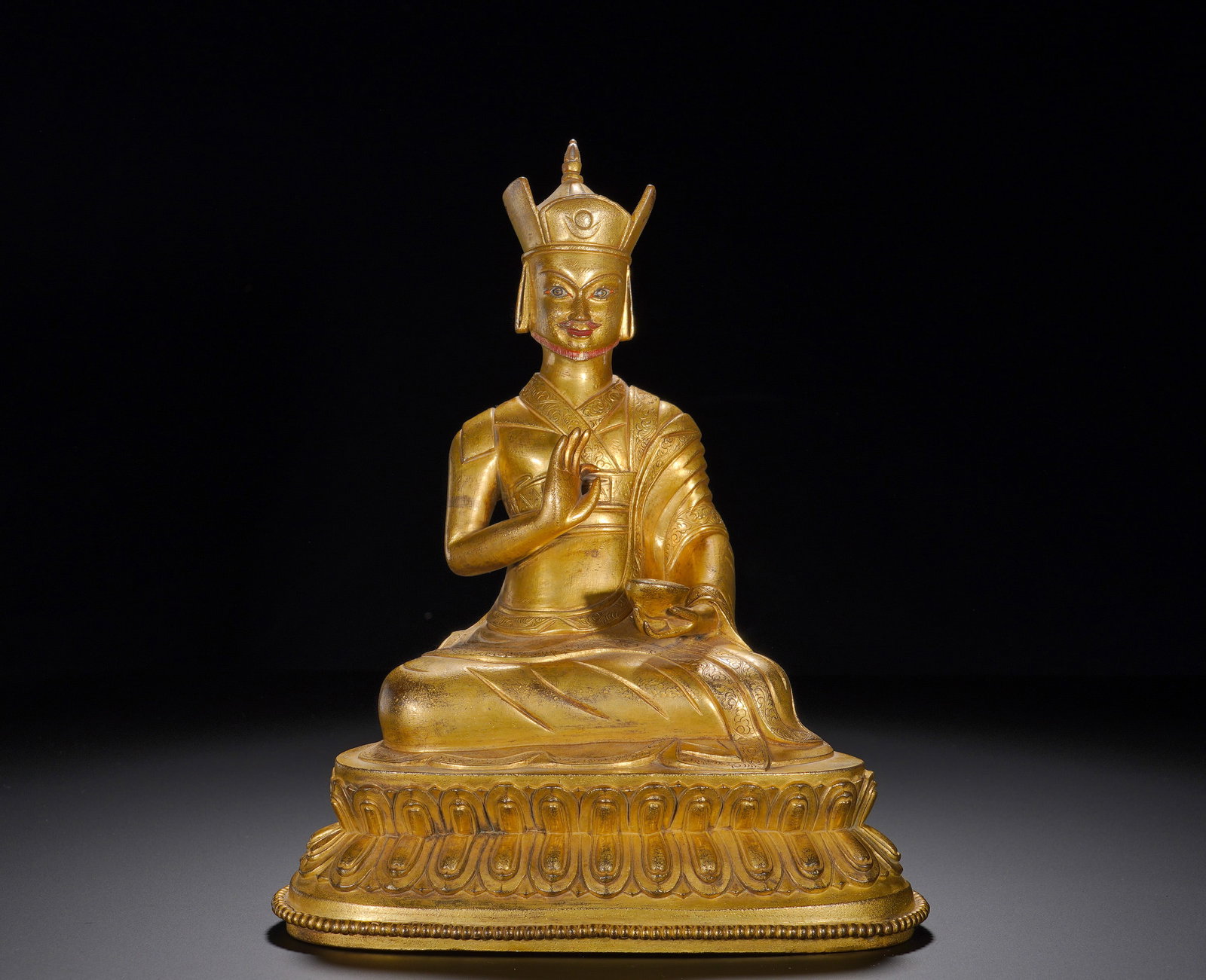 A gilded bronze statue of Padmasambhava from the Qing Dynasty: Height:24cm(9.45in), Width:20cm(7.87in), Weight:2640g (5.820lb)Gilt Bronze Statue of PadmasambhavaThis figure depicts Padmasambhava wearing his characteristic lotus crown adorned with an eye symbol.