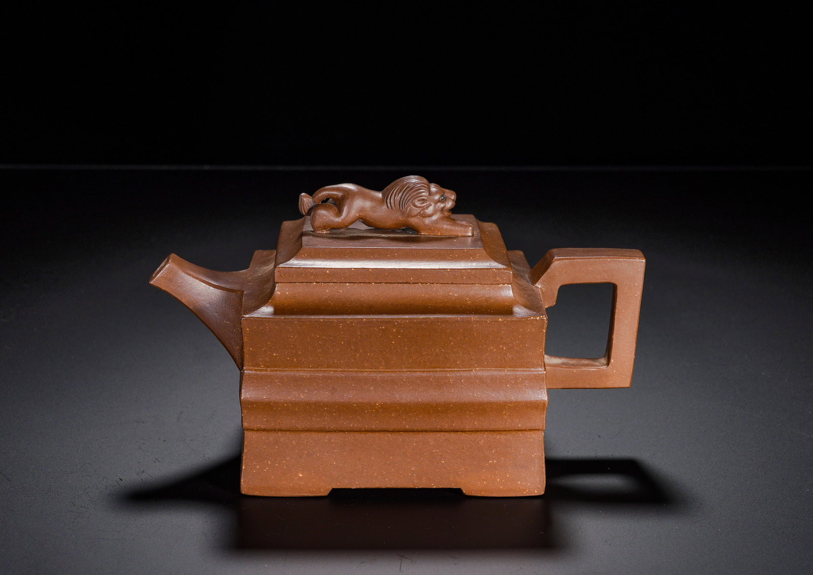 Purple clay lying Lion Square purple clay teapot: Height:10cm(3.94in), Width:17cm(6.69in), Weight:390g (0.860lb)This imposing square pot is an outstanding classic square-style zisha ware. The precisely squared body is constructed with segmented mould