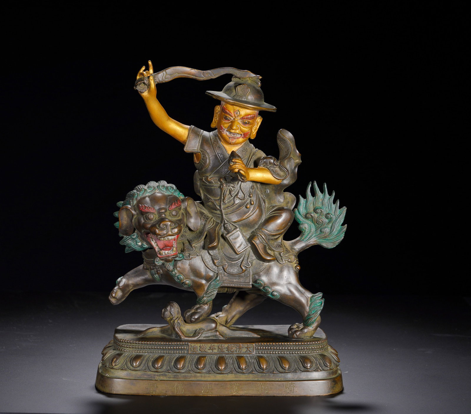 A bronze and gold statue of the Guardian Buddha Mother from the Qing Dynasty's Qianlong period: Height:31cm(12.20in), Width:22cm(8.66in), Weight:4580g (10.097lb)Part-Gilt Bronze Guardian Goddess Seated on LionMark: Respectfully made in the Qianlong reign of the Great Qing; base inscription: Guar