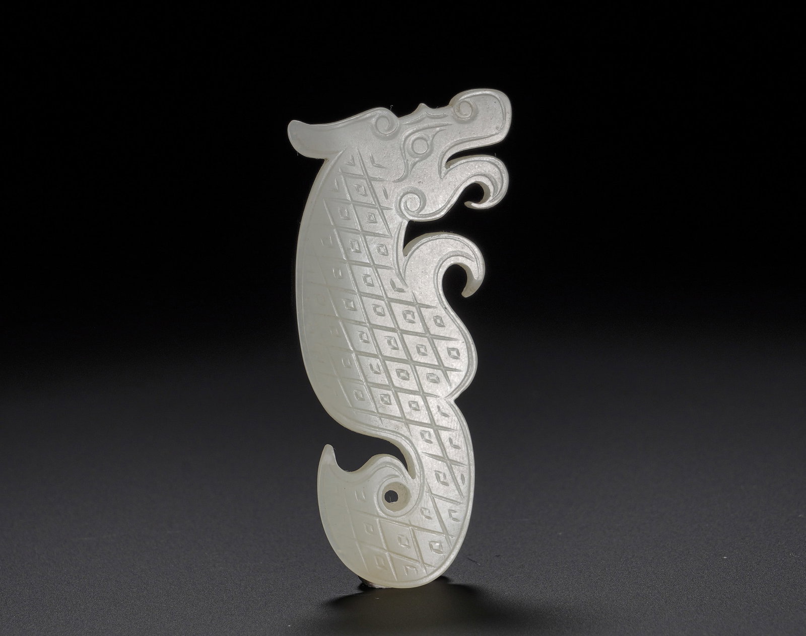 Hetian jade S-shaped dragon pendant from the Warring States period: Height:7.83cm(3.08in), Width:3.3cm(1.30in), Weight:20g (0.044lb)Carved from fine Hetian white jade with smooth and lustrous texture. The dragon twists in an elegant S?curve, with archaic?styled head, 