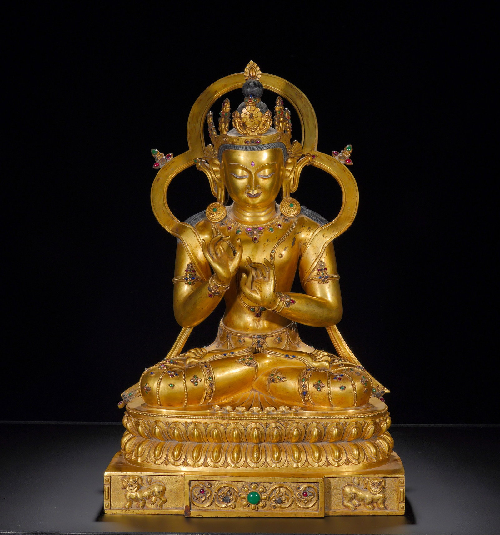 A gilded bronze statue of the Buddha with a lamp in the Xuande period of the Ming Dynasty: Height:62cm(24.41in), Width:41cm(16.14in), Weight:24700g (54.454lb)Dipankara Buddha wears an ornate crown, with a round and tranquil face, half-lidded eyes and a serene benevolent expression. A large 