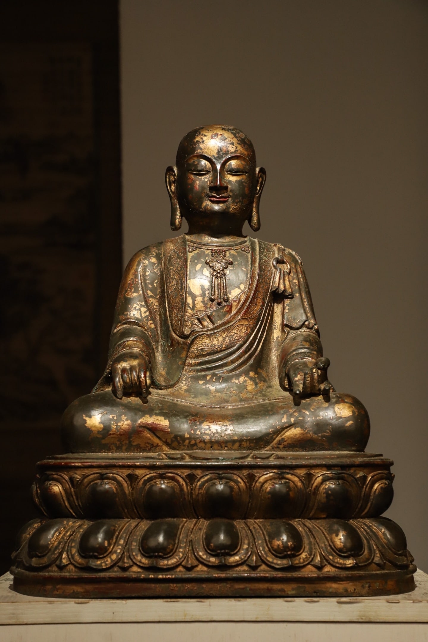 A seated statue of the Bodhisattva Di Zang in gilded bronze from the Ming Dynasty: Weight:20000g (44.092lb), Height:45cm(17.72in), Long:35cm(13.78in), Width:26cm(10.24in)This gilt bronze seated statue of Ksitigarbha Bodhisattva dates to the Ming Dynasty. Crafted in gilt bronze, its 
