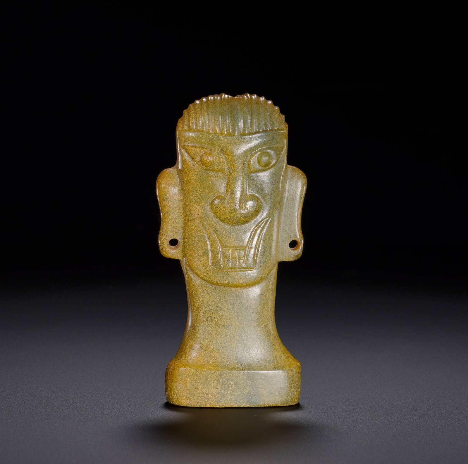 Shang Dynasty Hetian jade Divine Man's Head pendant: Height:9.5cm(3.74in), Width:4.7cm(1.85in), Weight:120g (0.265lb)Archaic Jade Human Deity Head PendantCarved from celadon jade, the entire surface is covered with yellowish-brown penetrating patina. Sh