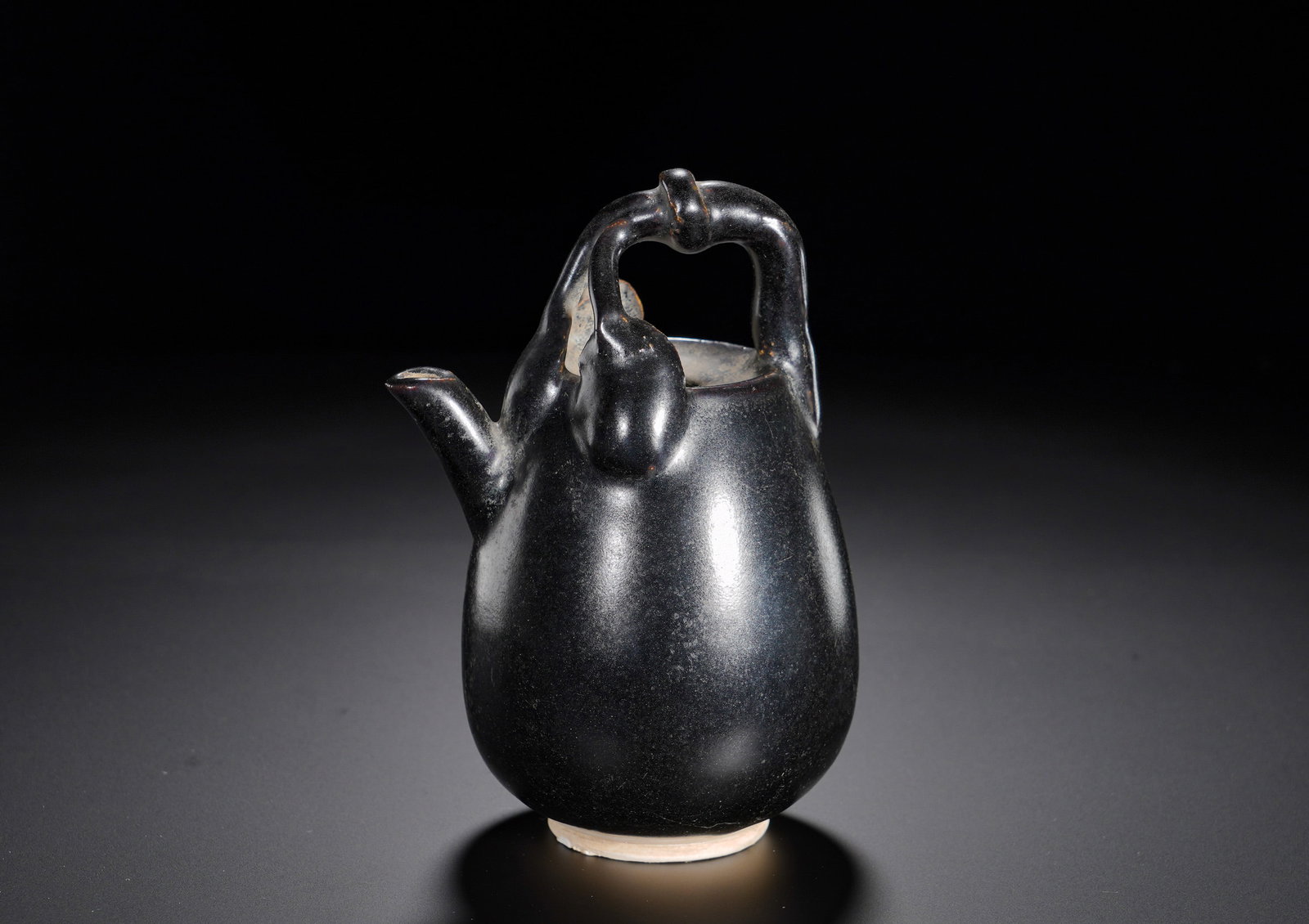 Song Dynasty Black glazed peach-shaped handle water jug: Height:14cm(5.51in), Width:10cm(3.94in), Weight:290g (0.639lb)Monochrome black-glazed wares were favoured by ancient literati for their quiet simplicity. The rare naturalistic peach motif and refined 