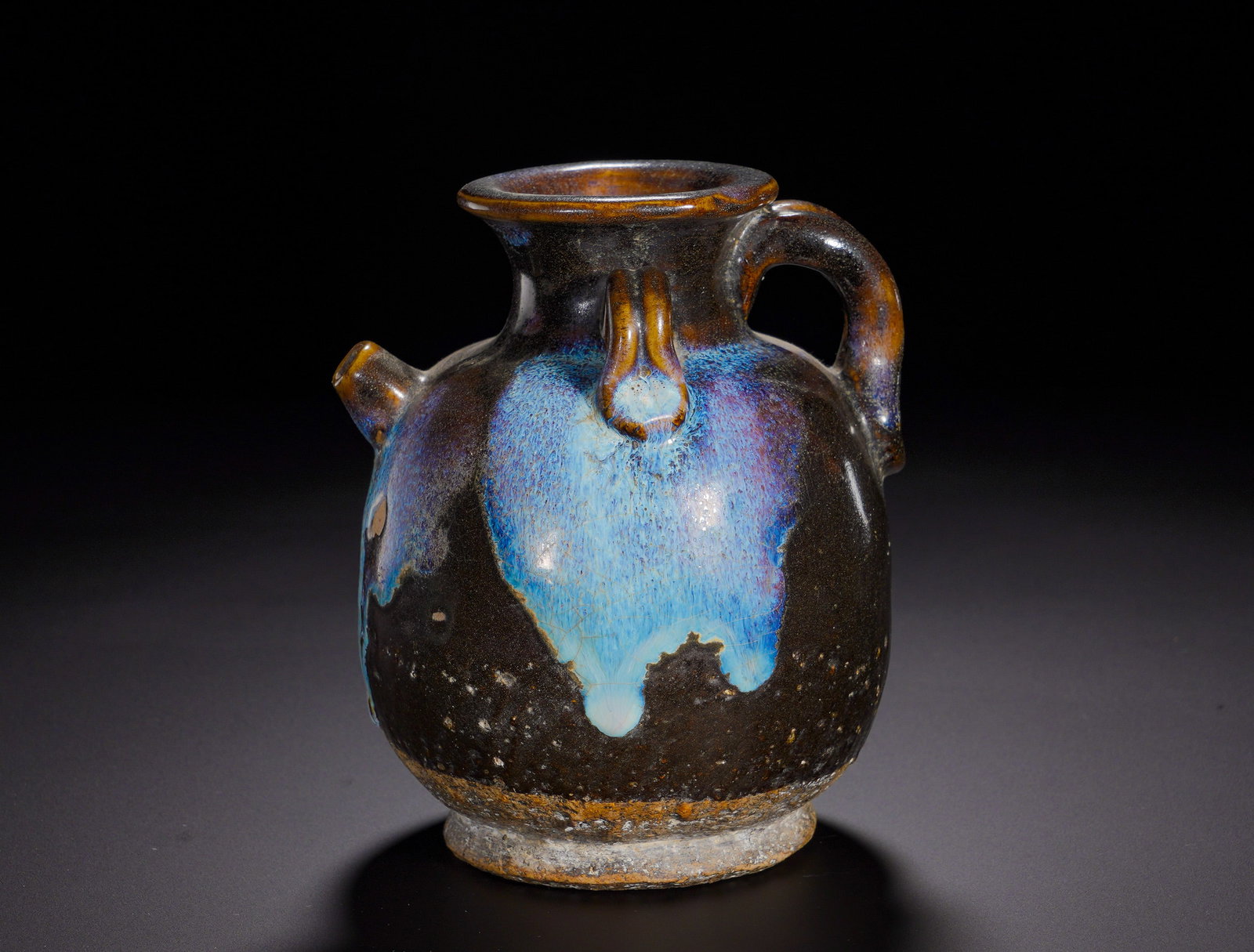 The Song Dynasty black glazed blue and splashed kiln variation ewer: Height:Missing, Width:Missing, Weight:MissingVariants of black wares with spontaneous coloured splash glazes date from Tang through Song-Yuan dynasties. Combining practical function with natural kiln 