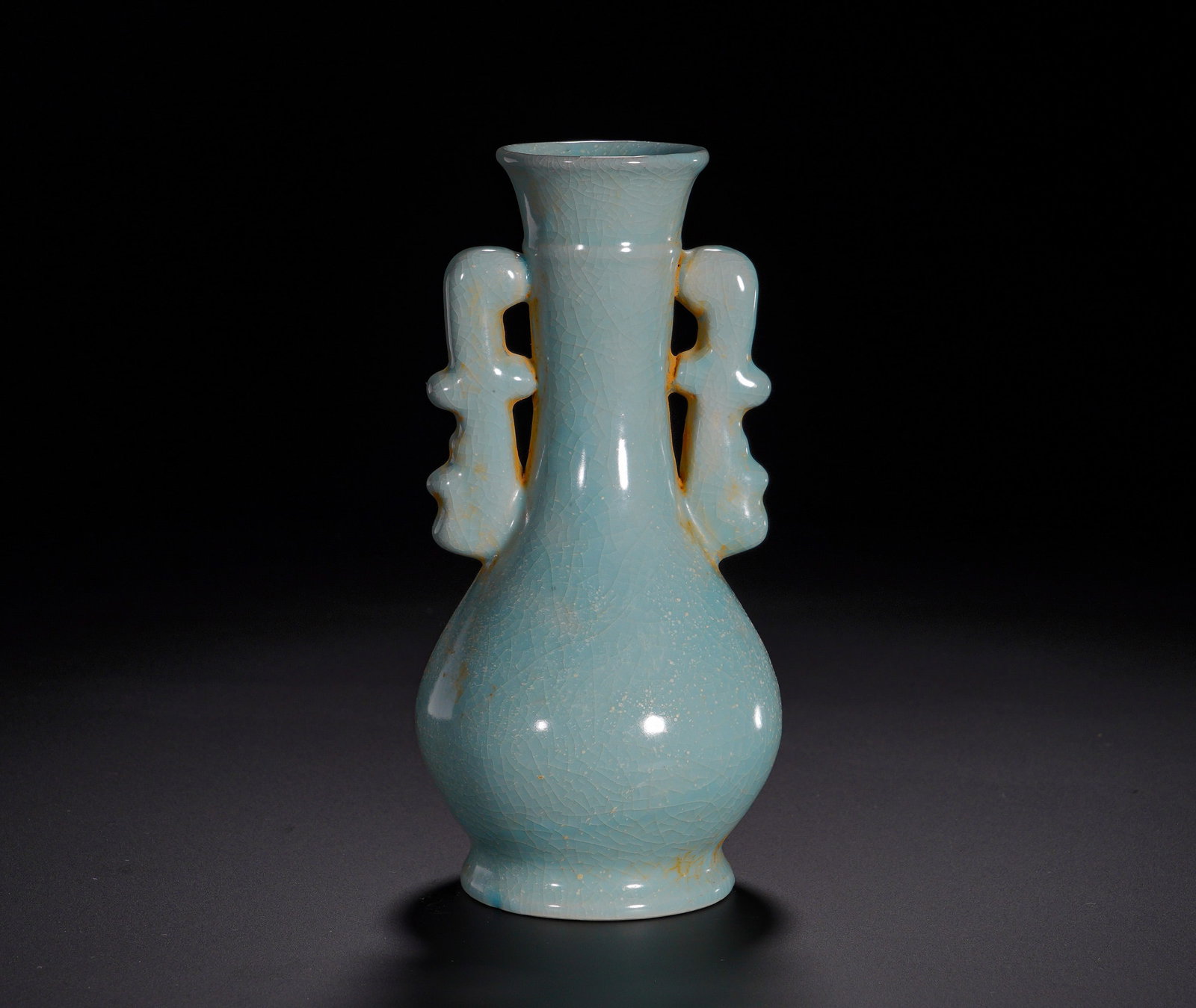 A celadon glaze halberd-ear bottle from the Ru Kiln of the Song Dynasty: Height:15cm(5.91in), Diameter:8cm(3.15in), Weight:230g (0.507lb)As the most revered among the Five Great Song Kilns, Ru ware is extremely scarce. Elegant and well-proportioned, this vase is ideal for