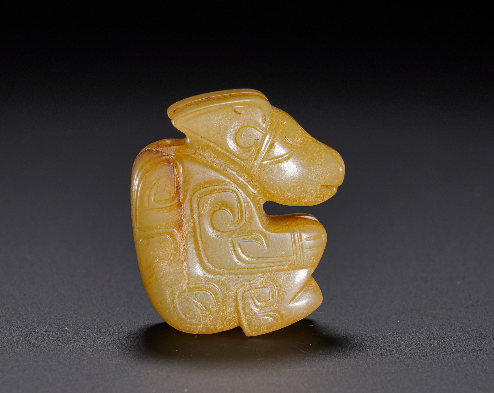 Shang Dynasty Hetian jade crouching beast pendant: Height:3.7cm(1.46in), Width:3.2cm(1.26in), Weight:30g (0.066lb)Archaic Jade Crouching Beast PendantFully carved crouching beast with mild jade suffused by pale yellow patina and natural aged texture.