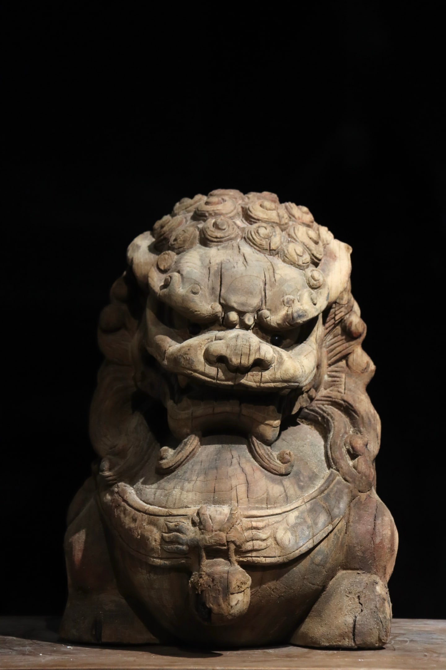 Song Dynasty woodcarving lion: Height:39cm (15.35in)Wooden lion guardian beast, spiral curly mane on head, bell hung on chest band, weathered wood texture, traditional Chinese auspicious carving