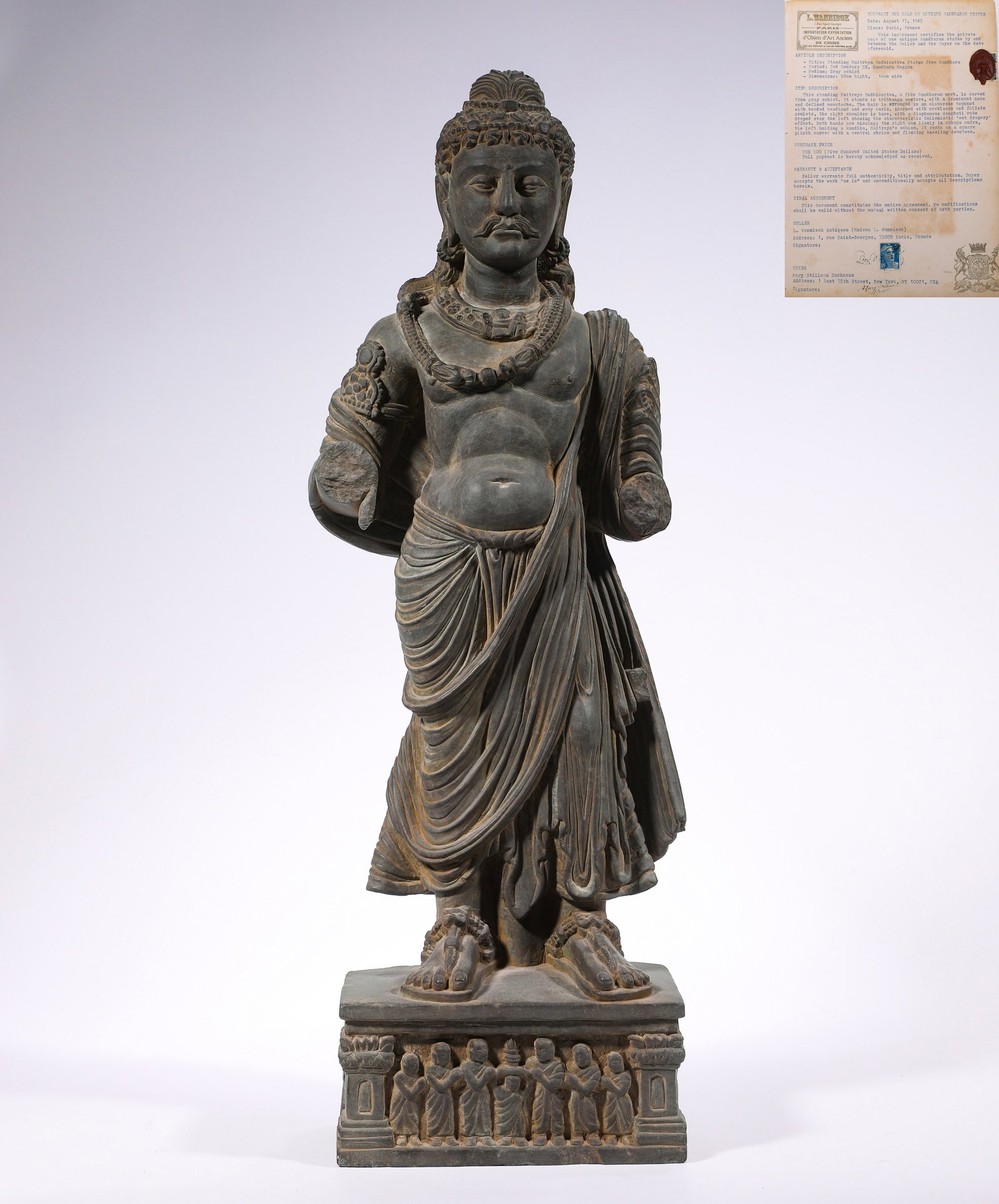 A standing statue of a Bodhisattva in the style of Gandhara from the 3rd century: H:50cmW:16cmWeight:8340g This Gandhara-style Bodhisattva Standing Statue, carved from schist, blends Greco-Roman drapery folds with Indian Buddhist iconography. Featuring flowing robes, a full-faced