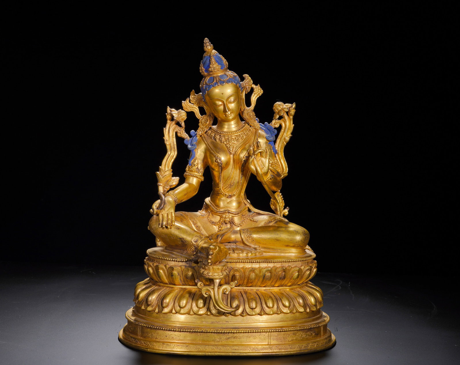 Bronze gilded white Tara statues of the Qing Dynasty: Height:26cm(10.24in), Width:38cm(14.96in), Weight:5860g (12.919lb)The statue of Green Tara is cast in gilt bronze, seated in royal ease upon a double-tier lotus base. She has a gentle and tranquil fac