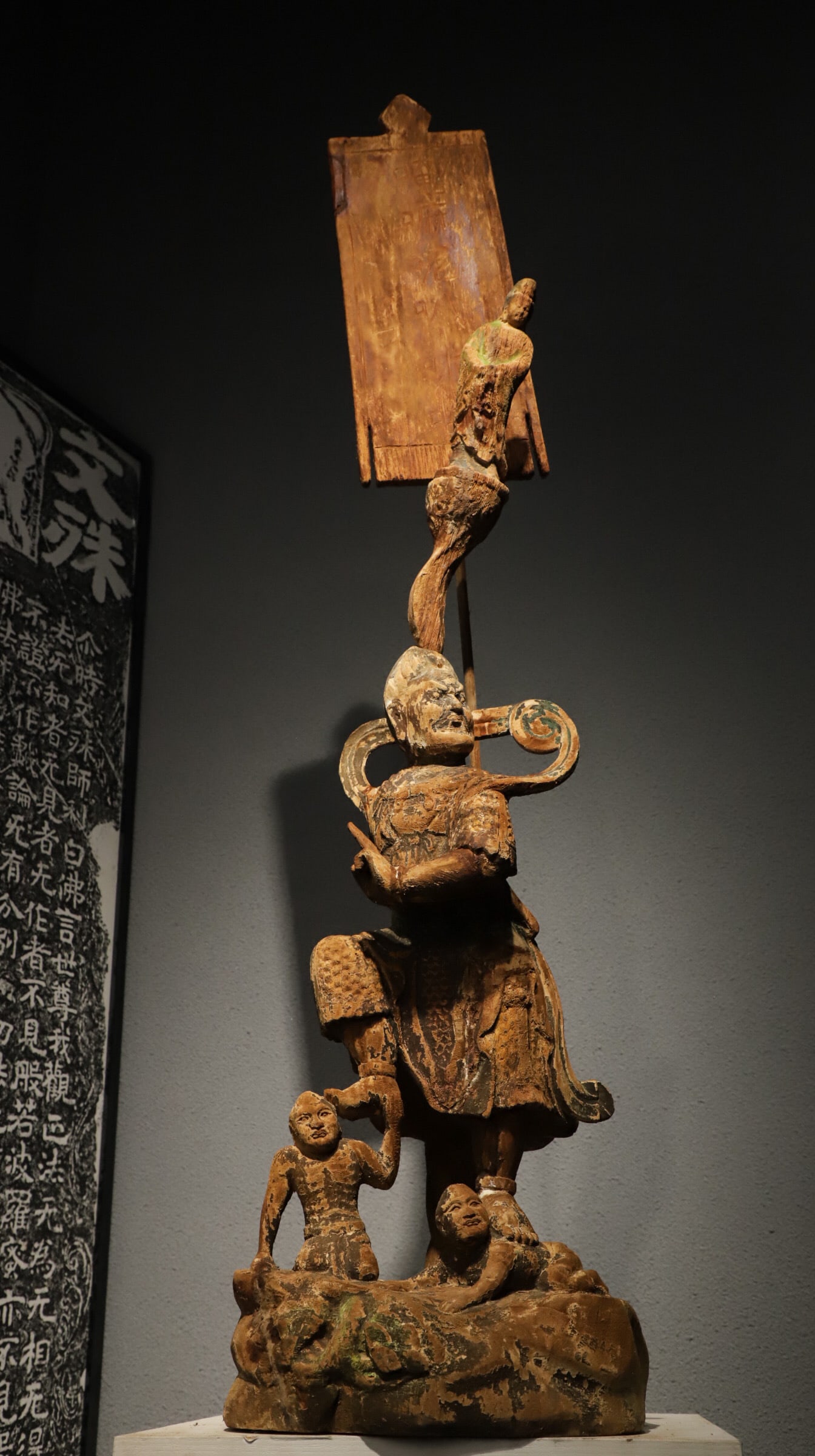 A painted wooden figure of a guardian general treading on a ghost from the Ming Dynasty: Height:125cm(49.21in), Long:30cm(11.81in), Width:25cm(9.84in)Representative folk woodcarving style of Central Plains in the Ming Dynasty, distinguished by unique layered three-dimensional carving