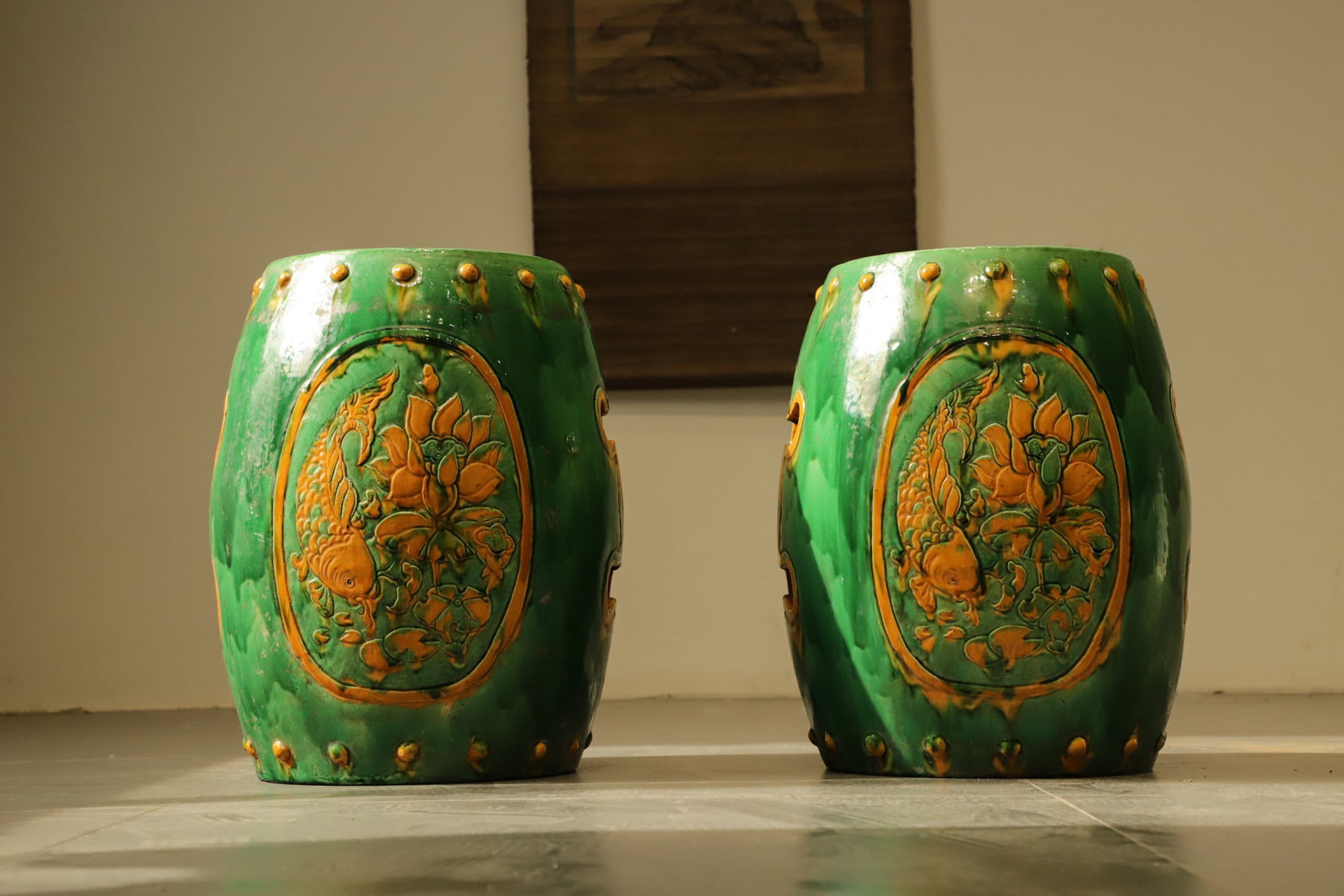 Tricolor glazed wares, lotus and fish patterned drum stools, embroidered piers: Height:40cm(15.75in), D:30cm(11.81in)Relief medallions depict the auspicious motif "Surplus Year after Year". Carp swimming among lotus flowers forms a homophonic blessing for lasting wealth and