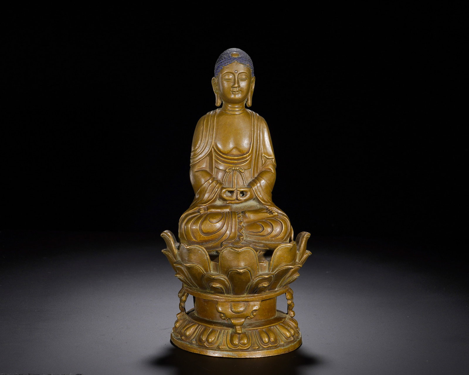 A copper seated statue of Sakyamuni in meditation from the Qing Dynasty: Height:25cm(9.84in), Width:12cm(4.72in), Weight:1630g (3.594lb)This is a bronze seated statue of Shakyamuni Buddha. The Buddha sits in full lotus posture on a double-layer upturned lotus pedestal,