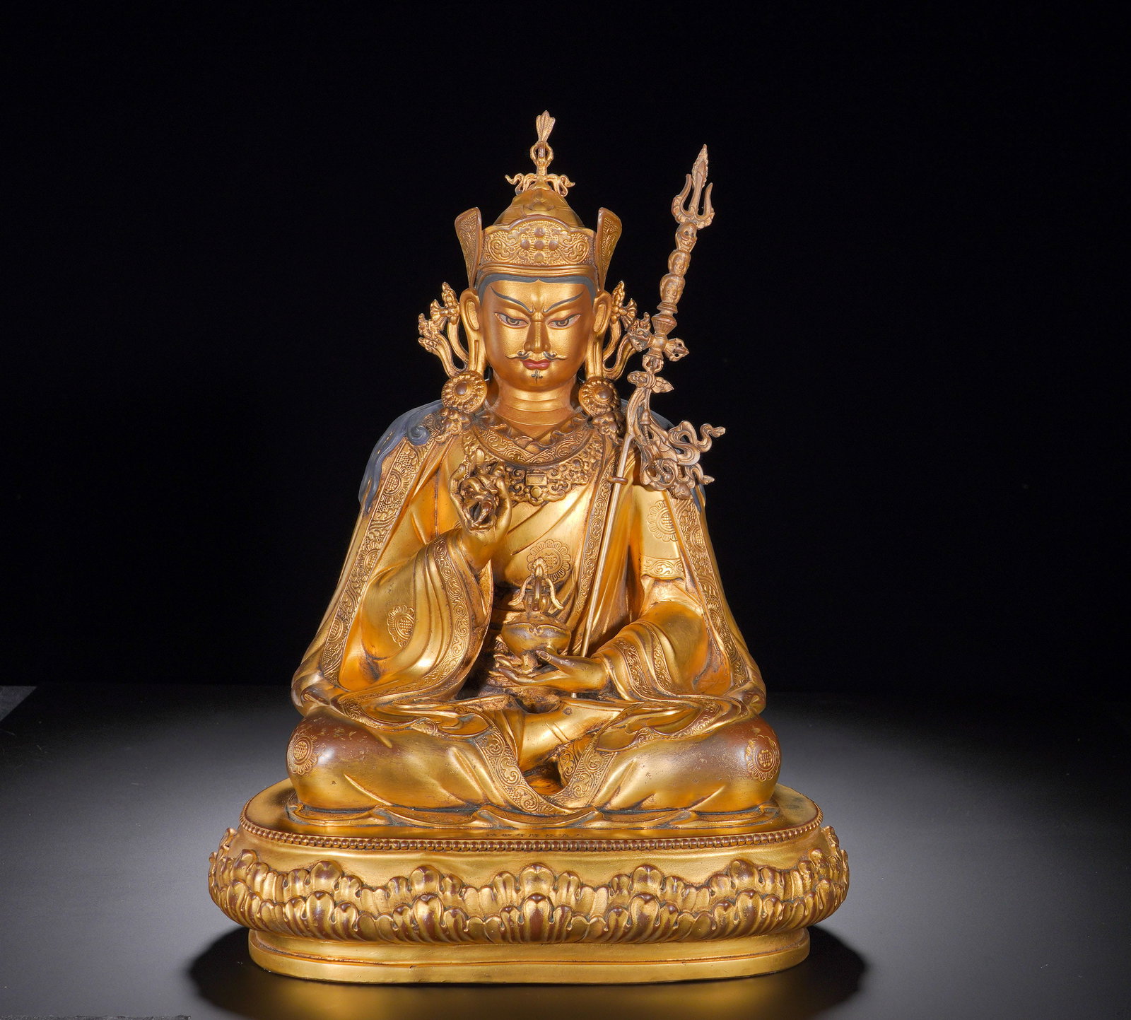Qing Dynasty Qianlong Gilded Copper Lotus and Peanut Master: Height:33cm(13.00in), Width:24cm(9.45in), Weight:4430g (9.766lb)This is a gilt-bronze seated statue of Padmasambhava. Guru Rinpoche sits in full lotus posture upon an upturned lotus pedestal, wearing