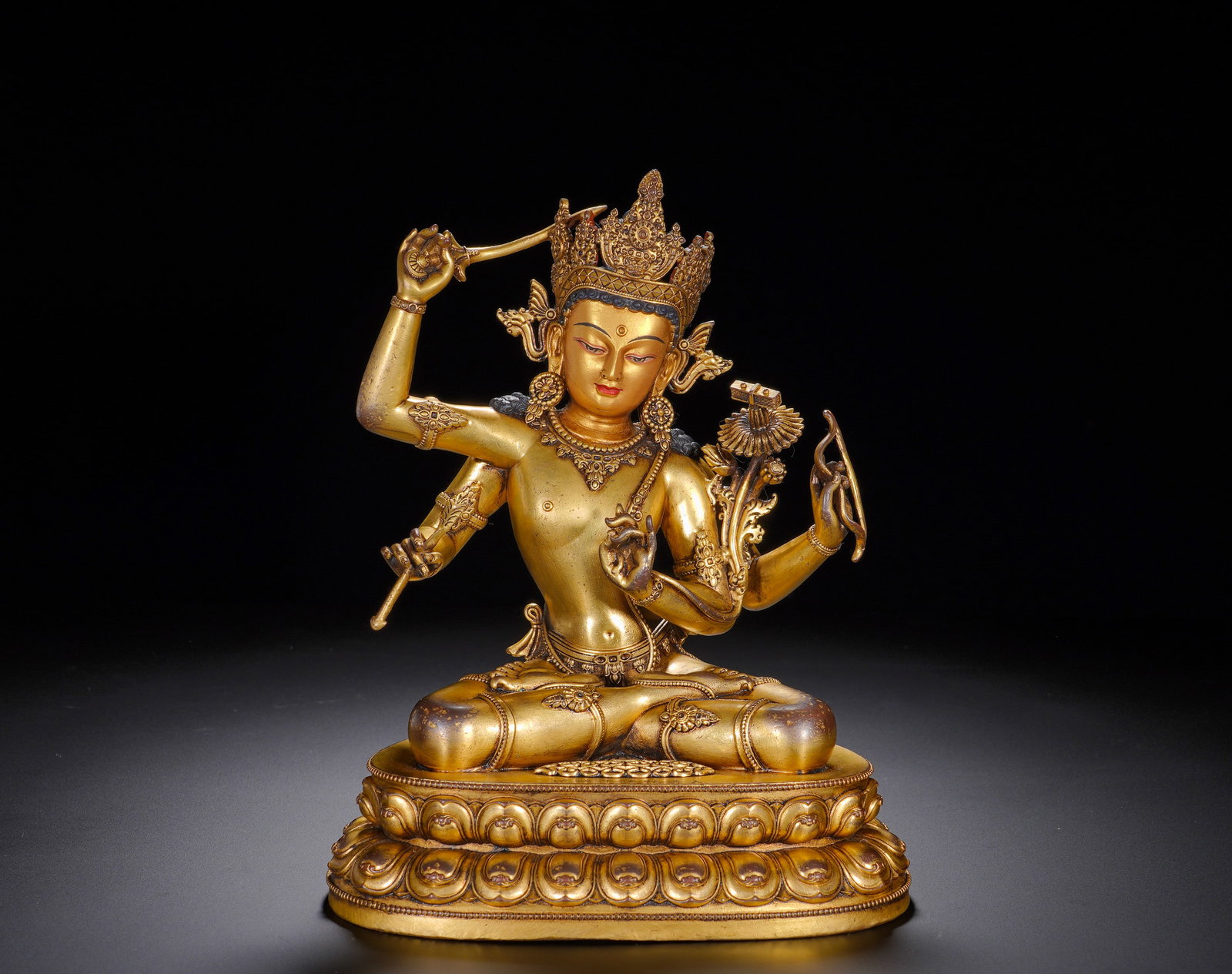 Gilded bronze Manjusri Bodhisattva from the Qianlong period of the Qing Dynasty: Height:20cm(7.87in), Width:16cm(6.30in), Weight:2050g (4.519lb)This is a gilt-bronze seated statue of Four-Armed Manjushri Bodhisattva, inscribed “Respectfully Made in the Qianlong Reign of the Grea