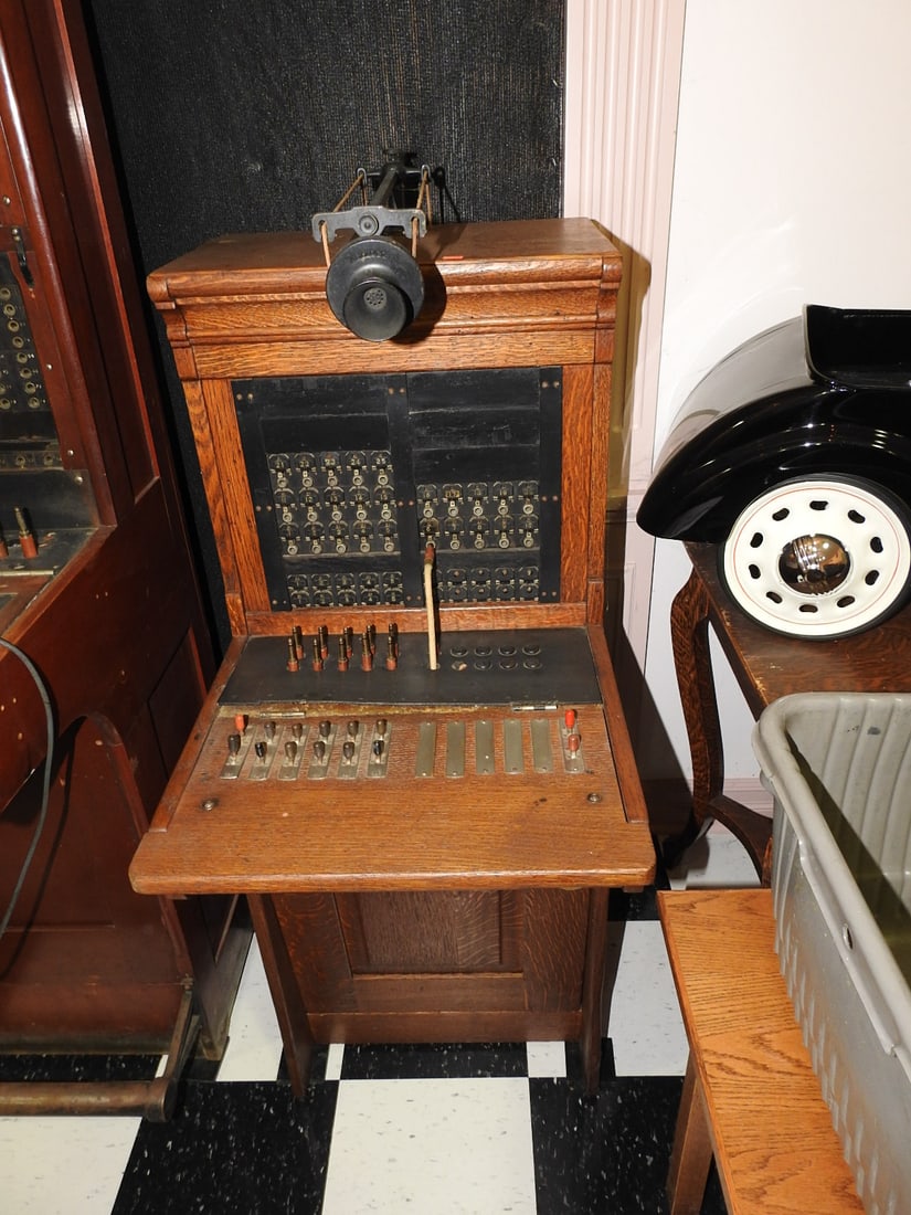 Antique Wooden Telephone Switchboard: Antique wooden telephone/operator switchboard with jack field, plugs, switches, receiver, and wood cabinet. No clear maker marking visible in photos. Approx. 53 x 19 x 27 in. Untested; shows finish