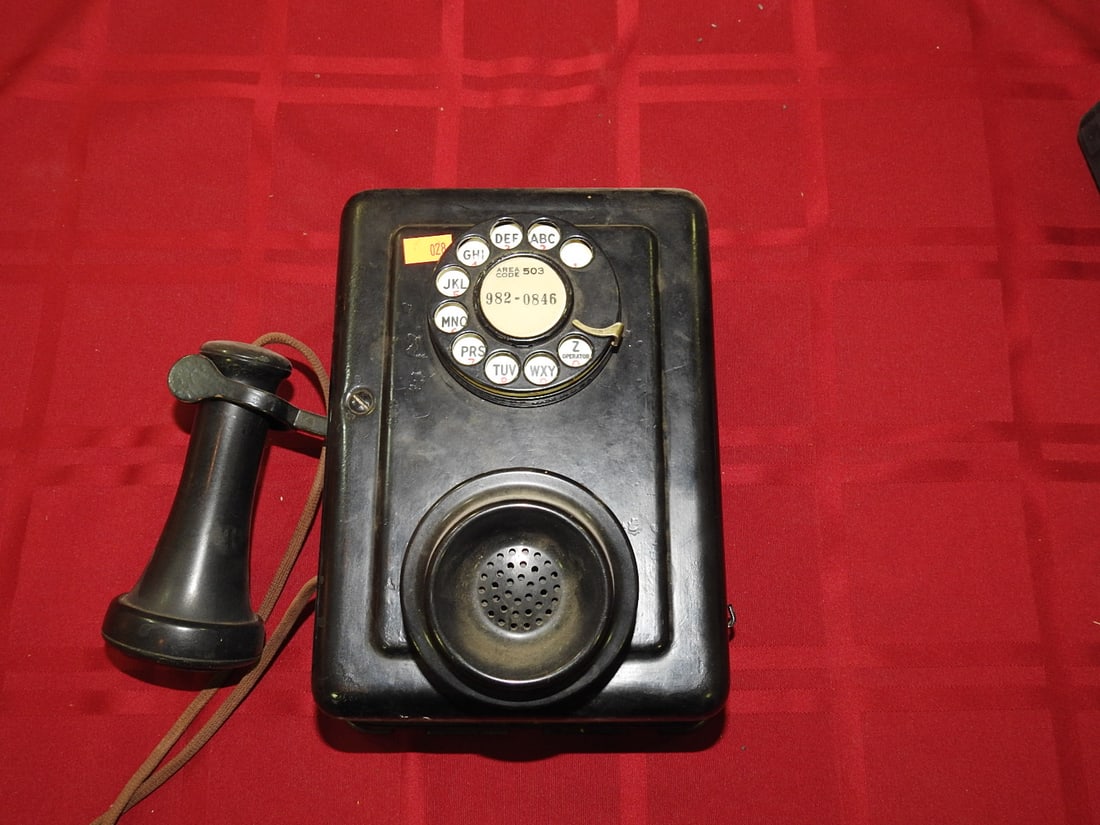 Black Rotary Telephone: Vintage black rotary telephone with handset, rotary dial, side vents, and area code/number card reading 503 / 982-0846. Maker not clearly visible in photos. Shows scratches, scuffs, finish wear, and c