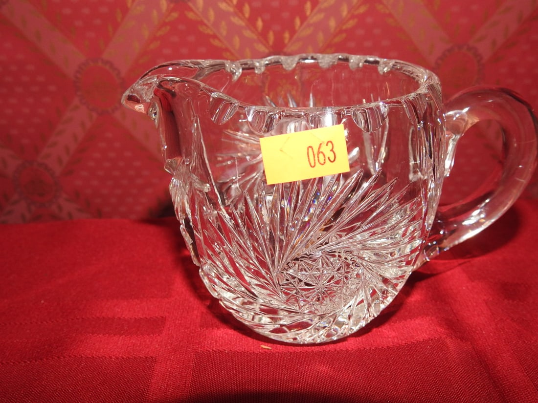 Cut Crystal Creamer with Fan and Hobstar Pattern: Vintage hand-cut crystal creamer with applied handle, fan and hobstar style decoration. Approx. 3 x 3 x 3 in. Unmarked unless otherwise noted; maker/pattern attribution is based on visible form, cuts 