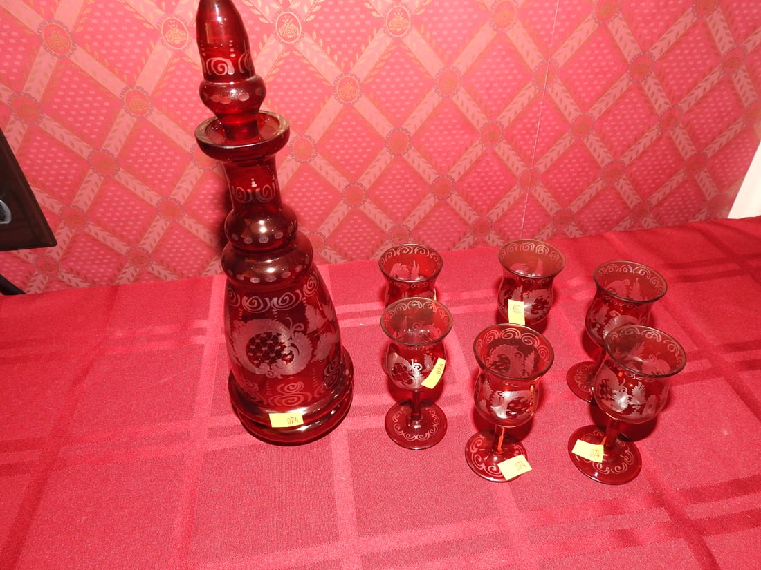 Ruby Flashed Etched Decanter with Six Cordials: Vintage ruby flashed and etched decanter set with stopper and six cordial glasses. Approx. 10.5 x 3.25 x 3.25 in. Set includes decanter and six cordial glasses. Unmarked unless otherwise noted; maker/