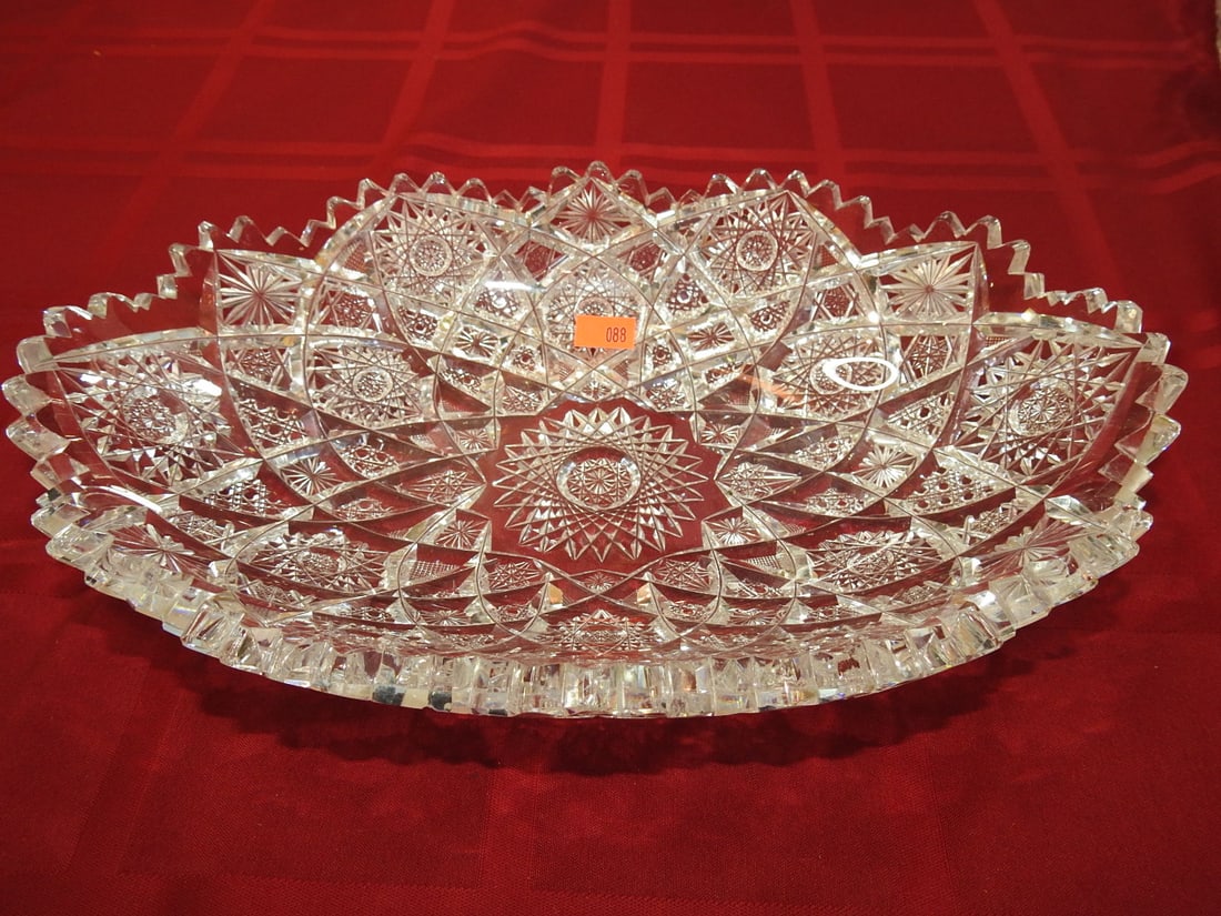 ABP Cut Glass Round Charger / Chop Plate: American Brilliant Period hand-cut glass round charger or chop plate with radial hobstar/fan decoration and scalloped rim. Approx. 7.5 x 11.5 x 2 in. Unmarked unless otherwise noted; maker/pattern