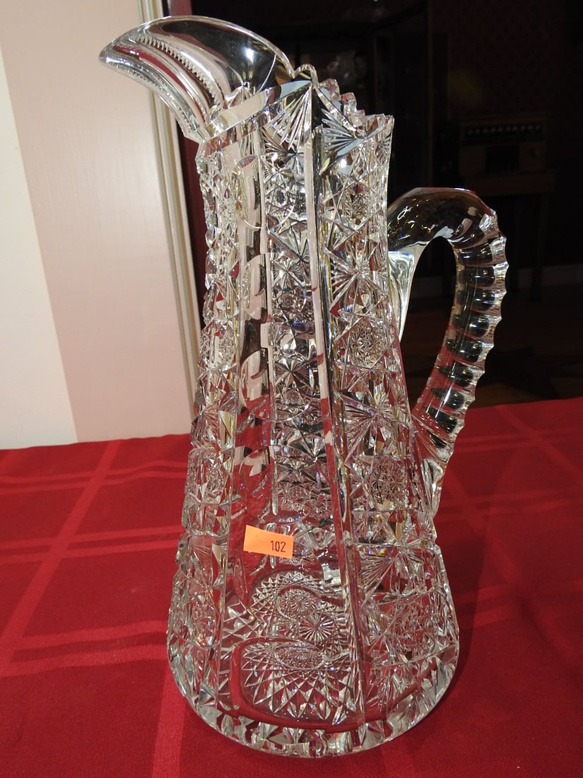 ABP Cut Glass Water Pitcher: American Brilliant Period hand-cut glass water pitcher with applied handle and geometric cut body. Approx. 11.5 x 6 x 6 in. Unmarked unless otherwise noted; maker/pattern attribution is based on visib