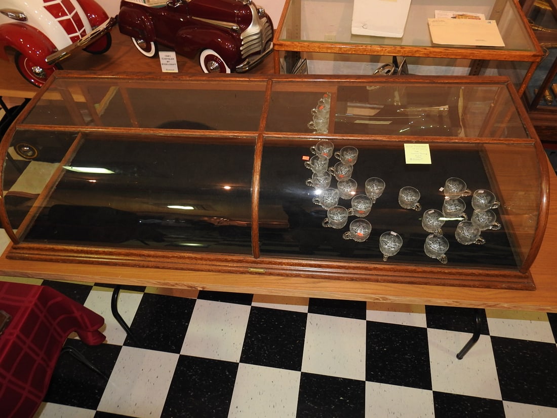 Lucky Mfg Co. Tabletop Glass Display Case: Antique tabletop glass display case marked The Lucky Manufacturing Company, Portland, Oregon. Contents shown are not included. Approx. 14.5 x 72.5 x 26.5 in. Shows age-related wear, patina, finish