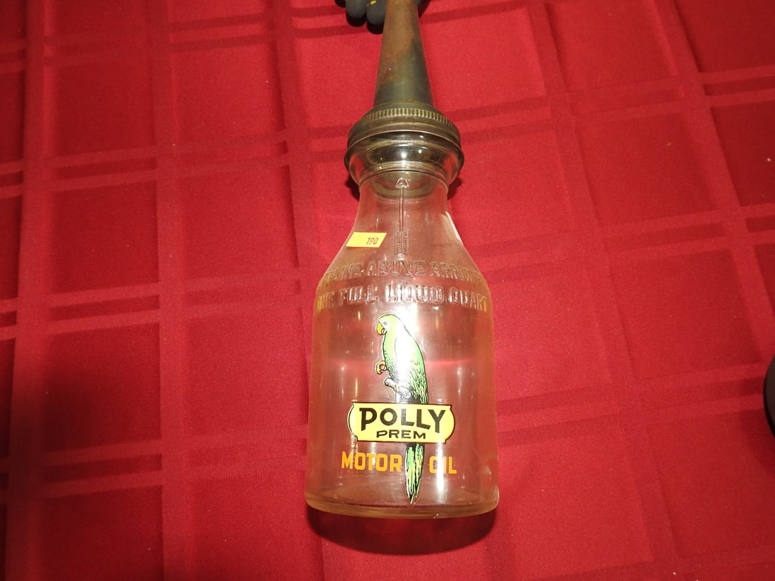 Polly Premium Motor Oil Glass Bottle with Spout: Antique quart glass oil bottle with Polly Premium Motor Oil label and metal spout. Approx. 13.5 x 3.75 x 3.75 in. Empty/decorative collectible; not tested for use. Shows age-related wear, patina,