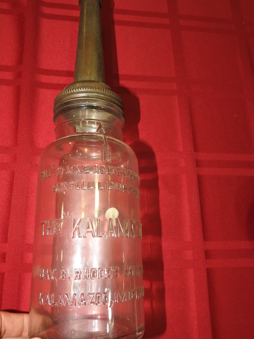 The Kalamazoo Quart Glass Oil Bottle Jay B. Rhodes: Antique quart glass oil bottle marked The Kalamazoo, Kalamazoo, Michigan per notes. Approx. 14.75 x 3.75 x 3.75 in. Empty/decorative collectible; not tested for use. Shows age-related wear, patina,