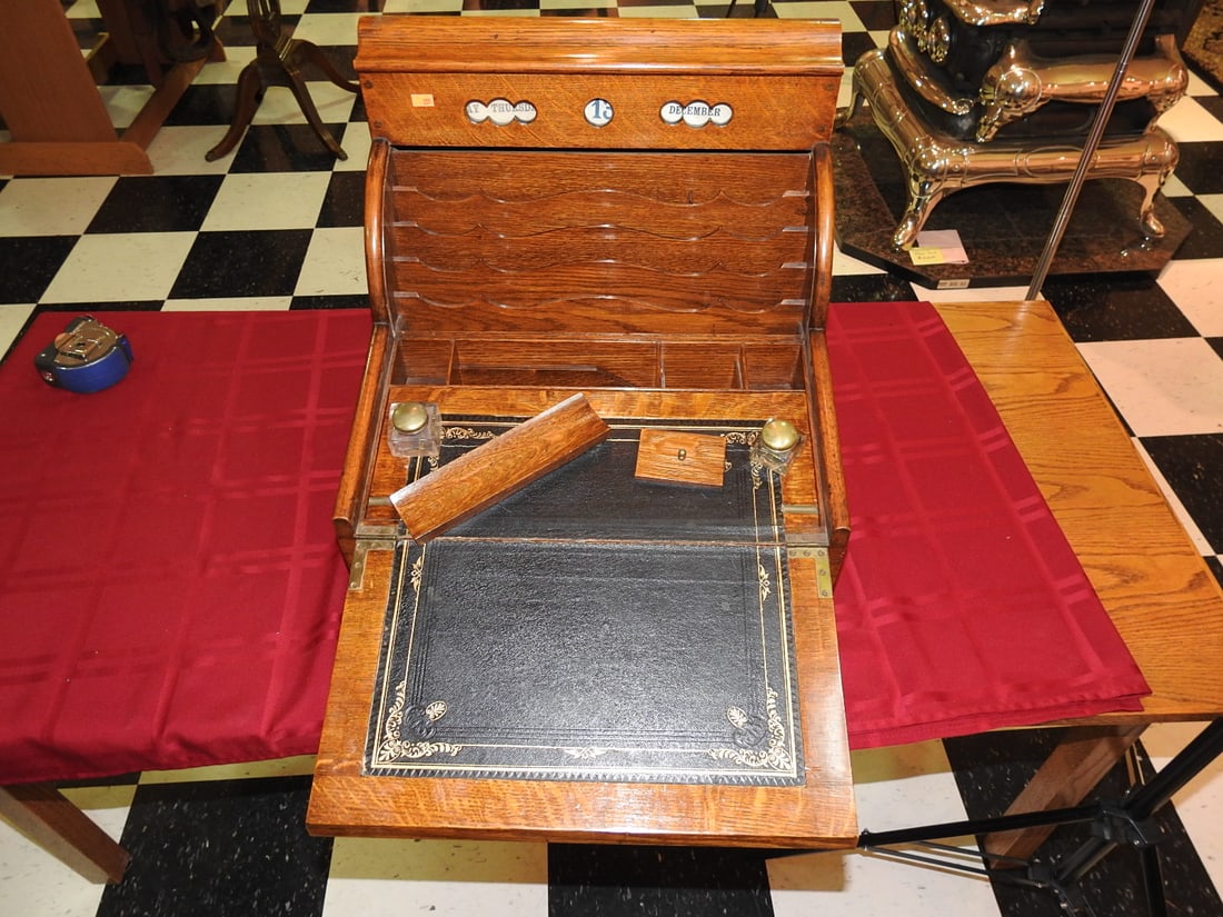 Antique Roll-Top Writing Slope with Ink Bottles: Antique oak roll-top writing slope/desk box with fitted interior, original ink bottles with brass tops and quill pen holder. Approx. 17 x 18 x 16 in. Roll-top action reported functional. Shows finish