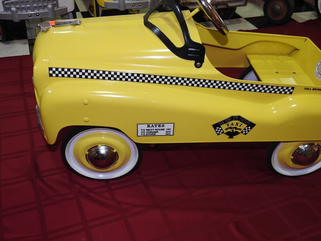 Burns Novelty Taxi Pedal Car: Limited edition Burns Novelty taxi pedal car in yellow with taxi graphics and chrome-style trim. Approx. 22 x 17 x 36 in. Shows light display wear, small scuffs, surface scratches and handling wear; s