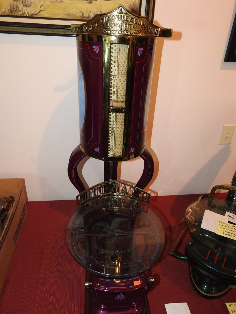 Restored Kansas City Scale, Maroon: Restored Kansas City scale in maroon finish with decorative side picture and upright weighing/display form. Approx. 37 x 16 x 30 in. Consignor notes indicate restored and operational. Shows light disp