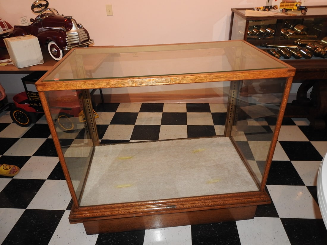 Oak and Glass Display Case: Vintage oak display case with glass enclosure and cabinet/base form. Approx. 42 x 46 x 26.5 in. Shows age/use wear, finish marks, scratches, glass wear, hardware wear and patina; see photos for condit
